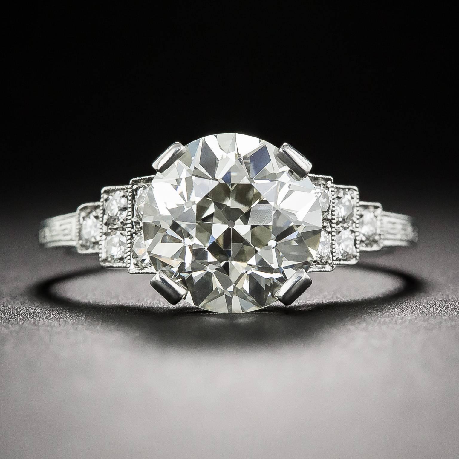 Sparkling diamond-set platinum steps, edged in fine milgrain, lead to a splendid 2.58 carat European-cut diamond, which comes with a GIA Report stating: L color, VS1 clarity. 

The dazzling center diamond is set within four broad prongs, which
