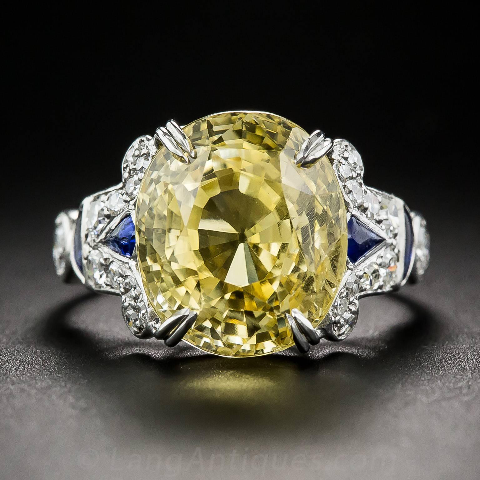 Eternal sunshine on your finger! An entrancing, electric yellow, natural, no-heat Ceylon sapphire, weighing 12.03 carats, radiates from within its Art Deco style setting, in this rare and wonderful Jazz Age inspired jewel. In addition to four split