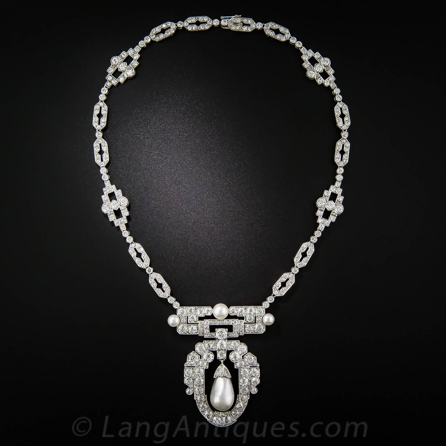 Radiant and ravishing. This truly exquisite necklace, hailing from the peak of the Art Deco period - circa 1925, although unsigned, is worthy of the finest jewelry houses. Centering on a lustrous white, natural saltwater pearl drop, measuring 18.70