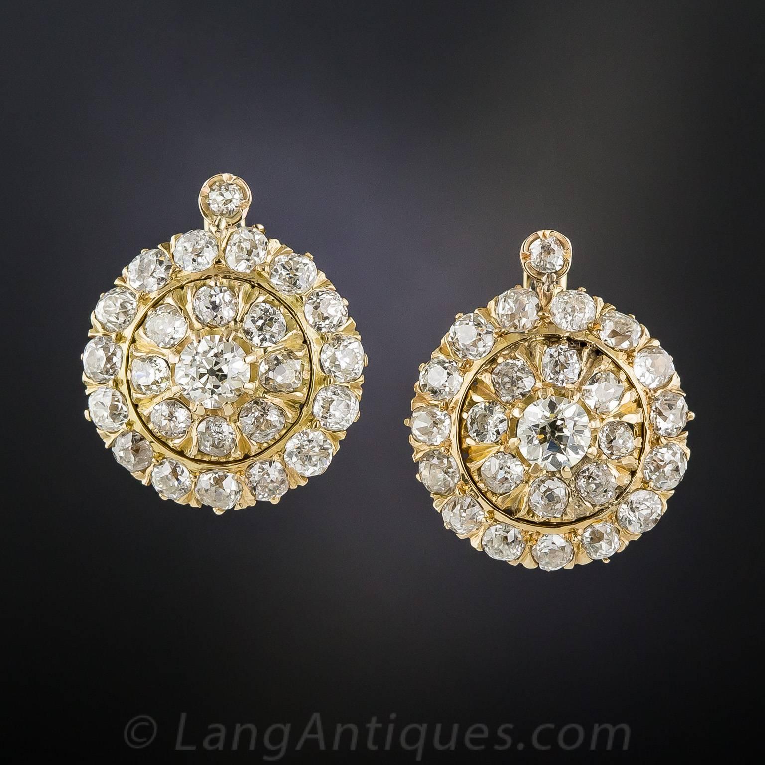 50 bright white and beautiful old mine-cut diamonds, weighing a total of 8.00 carats, are packed into the concentric circles of these super-sparklers, crafted circa 1900, in gleaming 14K gold. The dazzling discs (7/8 inch diameter) are surmounted by