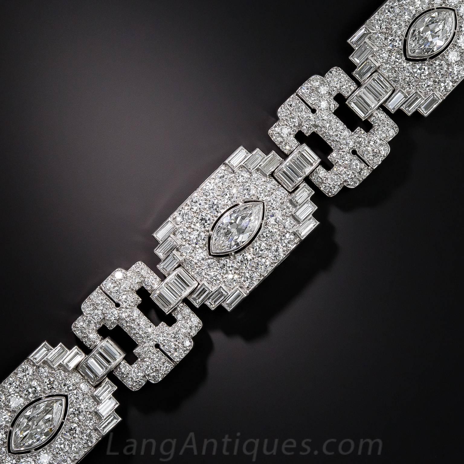 Although (oddly) unsigned, this spectacular platinum and diamond Art Deco bracelet, circa 1930, is more than worthy of bearing the signature of the very finest French or American jewelers. Each of the four gently curved geometric sections is