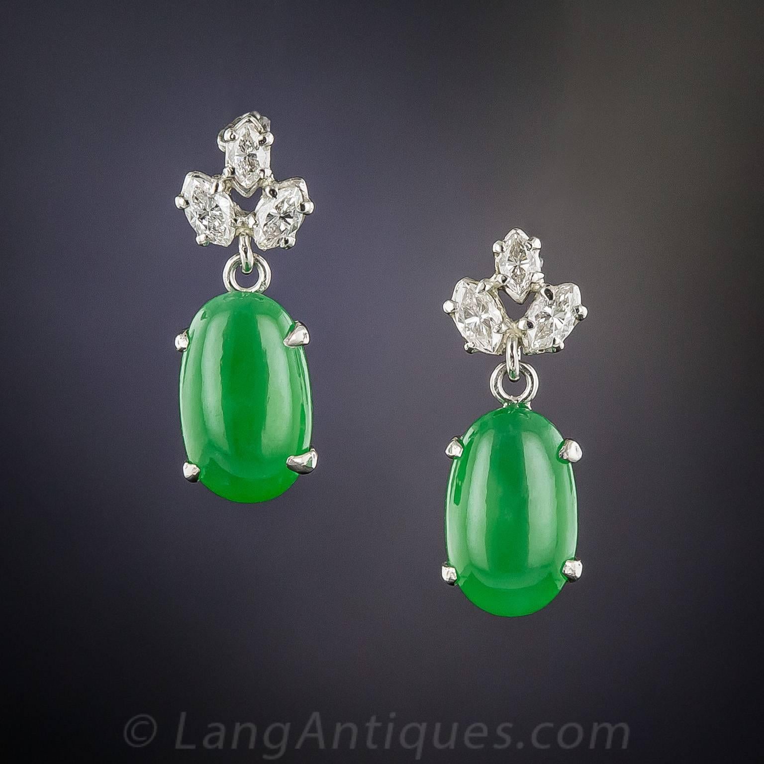 A relatively small but sweet (and extremely fine), matched pair of natural, translucent Burmese jade cabachons, with a bright and beautiful rich green hue, dangle from trios of bright white marquise diamonds, all of which are set in platinum. Just