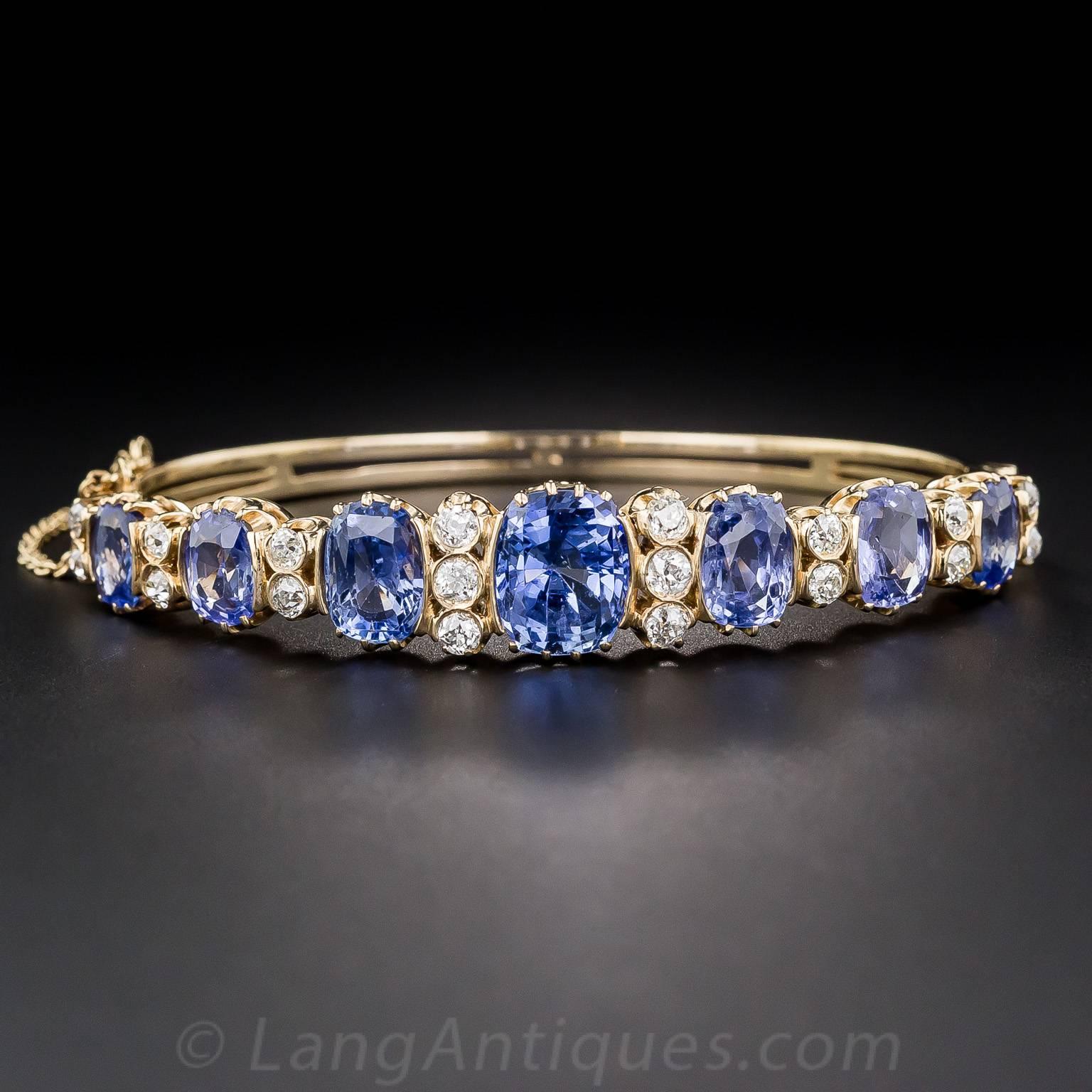 Wrap your wrist with lucky seven beautiful, bright and shining, cornflower blue sapphires (all natural, no-heat, Ceylon origin) in this seriously stunning and impressive bangle bracelet, handcrafted in 15K yellow gold (hence very likely of British