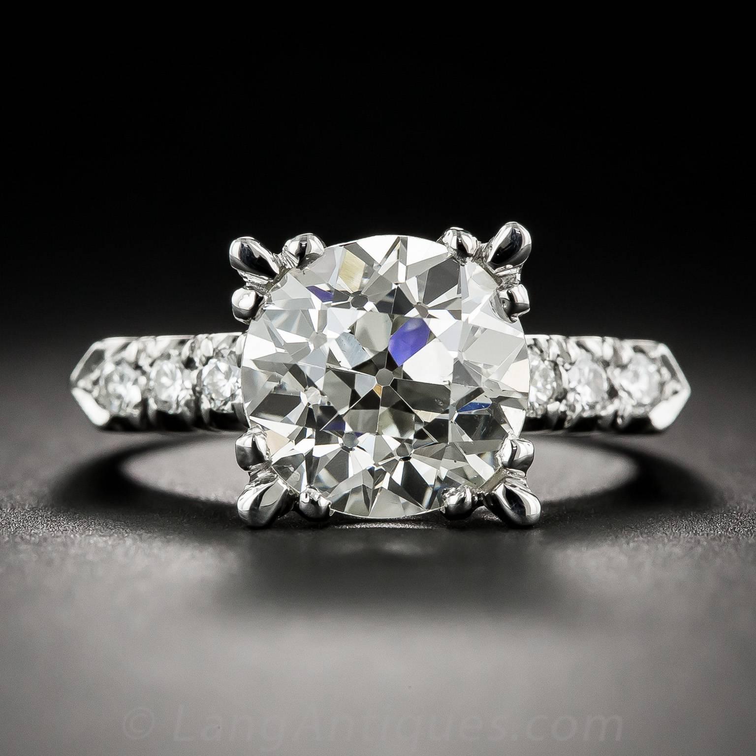 Bright, brilliant, blazing and amazing! Although weighing in just five points shy of 4 carats, this exuberant ultra-sparkler appears even larger and more impressive due to its striking, flared four-cornered setting, handcrafted in platinum - circa