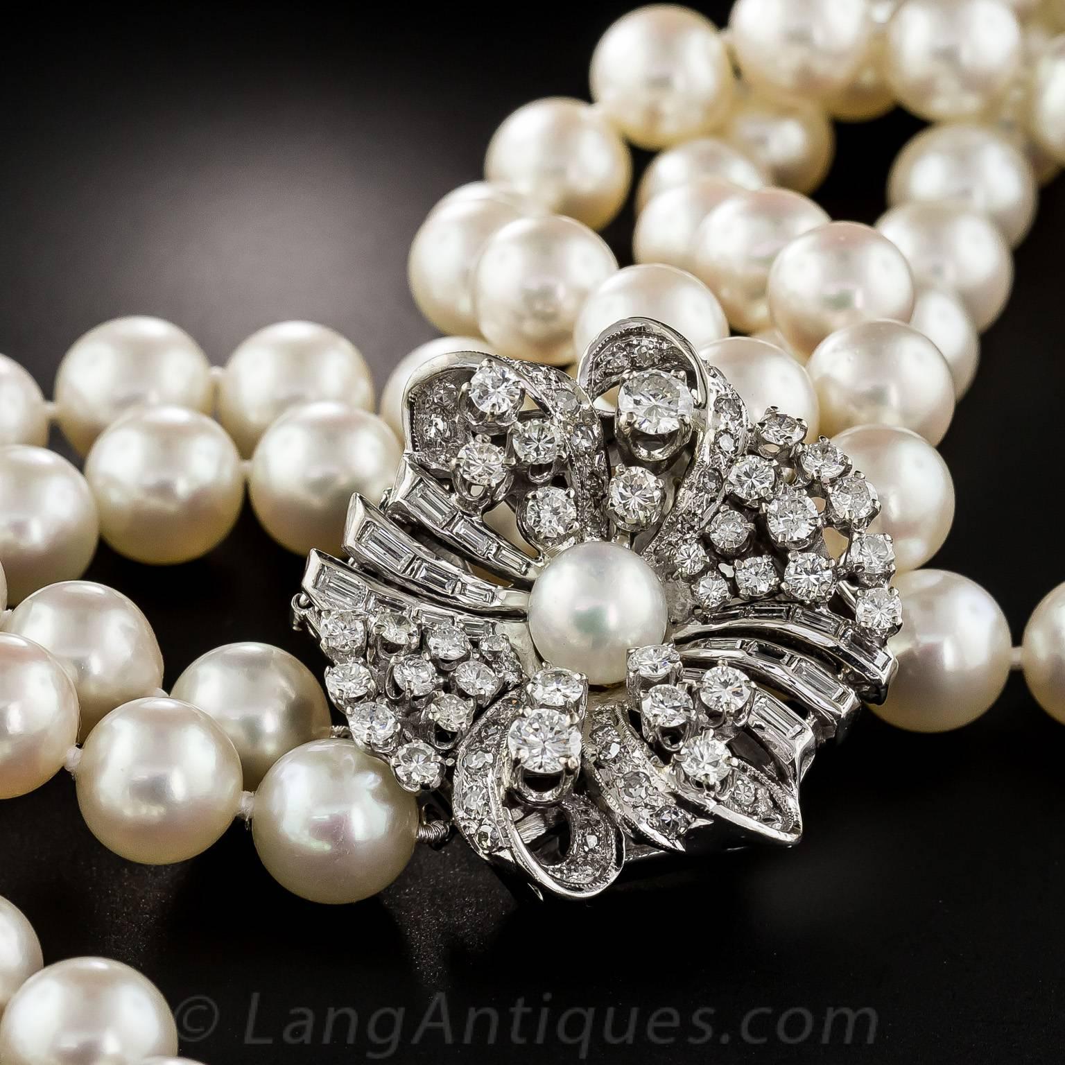Lustrous double strands of 9.5 - 9.0 millimeter white, creamy, dreamy cultured pearls culminate in a scintillating constellation of bright white and brilliant round and baguette diamonds in this elegant, ultra-sparkling showstopper, evocative of