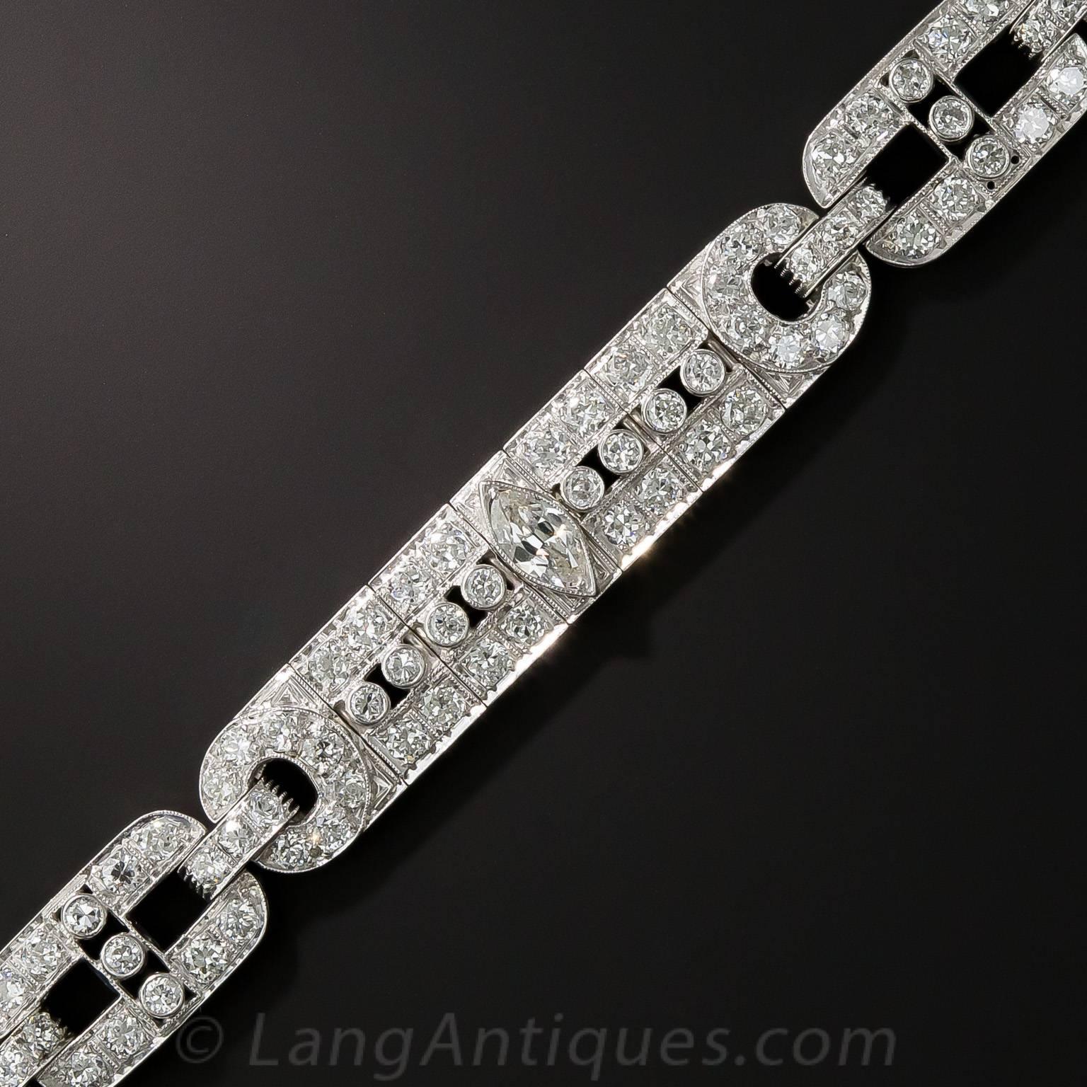Three-eighths inches wide, and thus eminently wearable, this consummate platinum and diamond Art Deco jewel dates from the peak of the period - circa 1925-35. The sleek and lithely constructed bracelet is packed with 6.25 carats of bright white