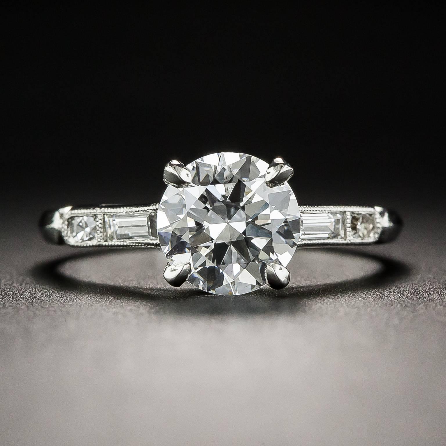 They don't come any whiter or brighter than this sensational 1.39 carat transitional European/round brilliant-cut diamond sizzling between a pair of slender baguettes, followed by small round diamonds, leading to a sleek knife-edge ring shank in