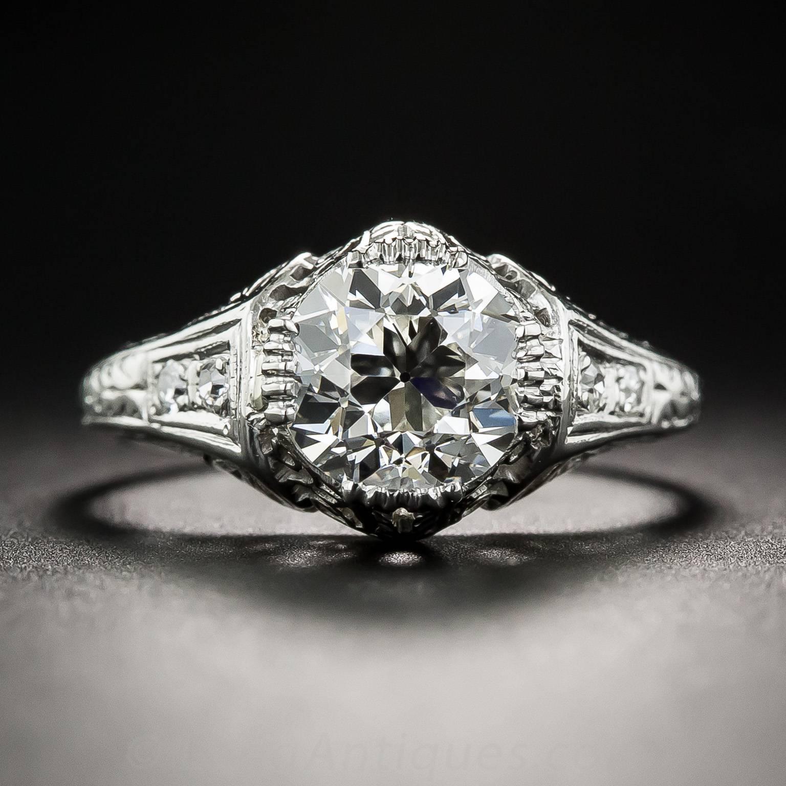 Neoclassical design motifs distinguishes this refined and radiant Art Deco dazzler, hand-fabricated in platinum with hand-pierced and engraved details - circa 1920s-30s. Featuring a gorgeous bright-white and brilliant European-cut diamond, weighing