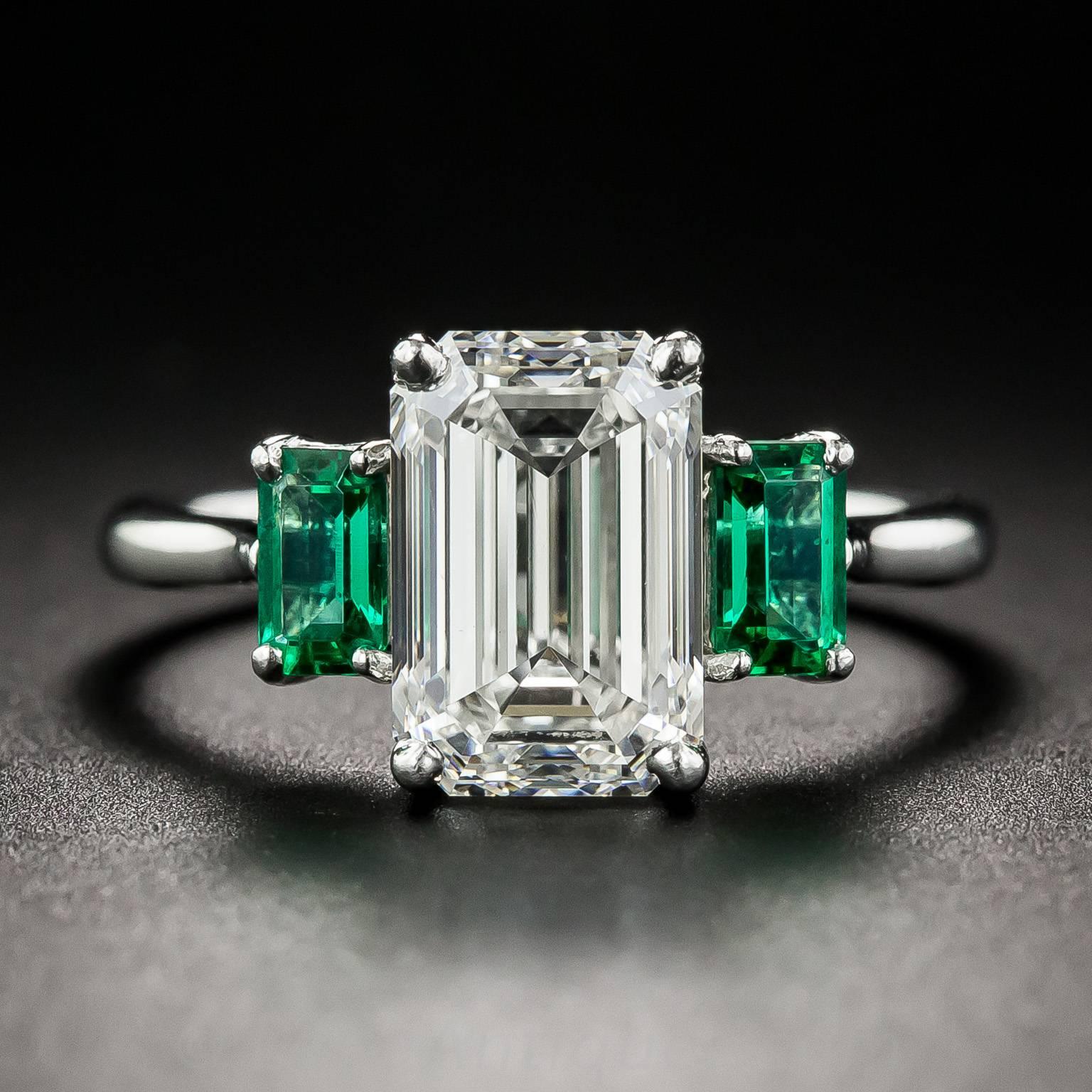 A beautiful bright white, high-quality emerald-cut diamond, weighing 3.01 carats, takes center stage in this resplendent, radiant and ravishing jewel. The classically modeled diamond sparkles between a rare and gemmy matched pair of of vibrant