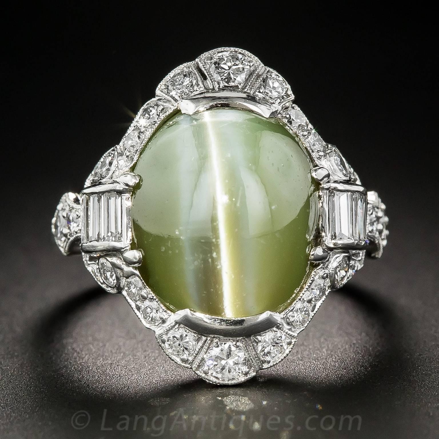 A rare, gorgeous, exotic and impressive Art Deco jewel dating from the peak of the period - circa 1925. A mesmerizing gemstone, a gemmy chrysoberyl cat's-eye, weighing a sizable 18.50 carats, and imbued with a majestic khaki green hue, winks at you