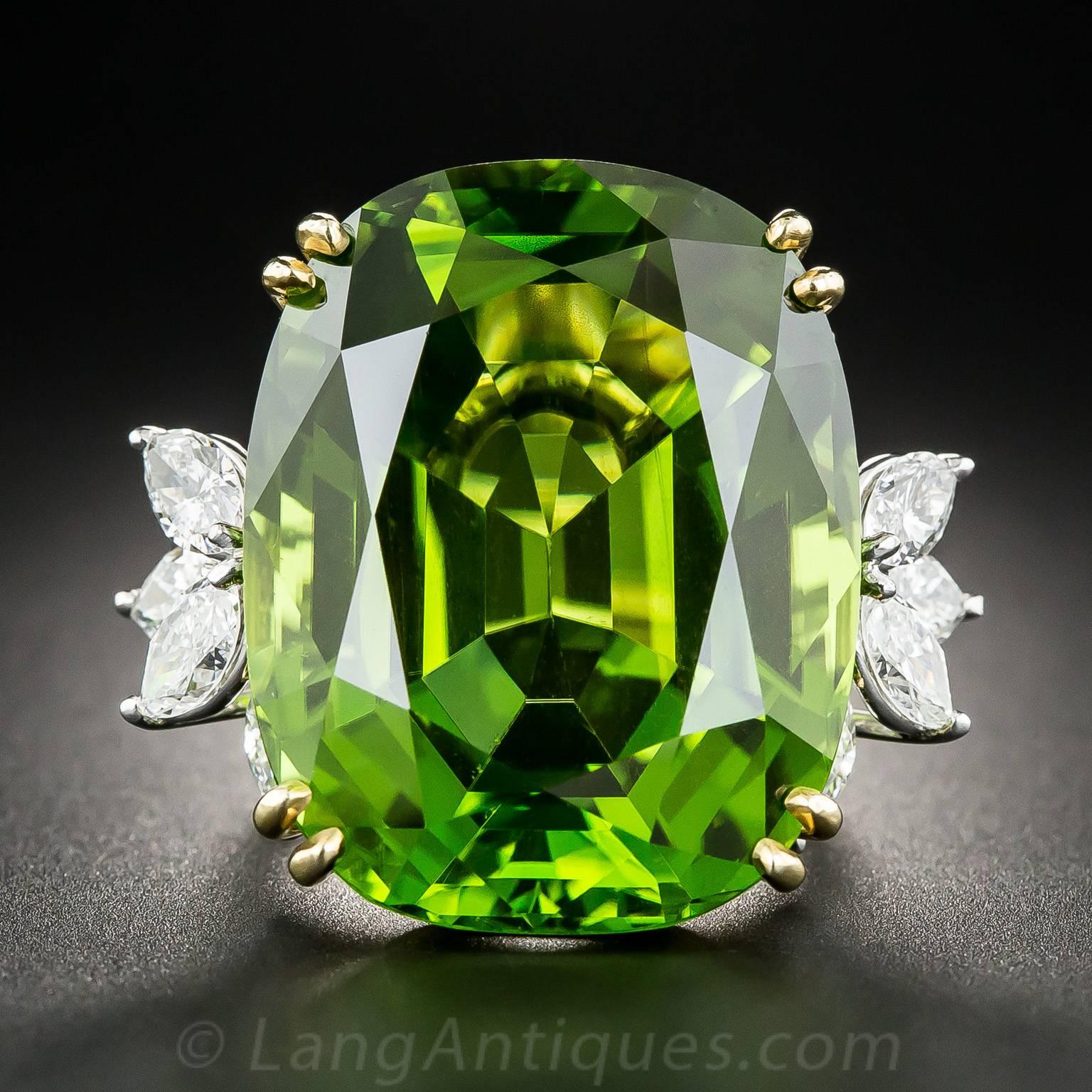 A gem and a knockout! No two-dimensional image can begin to do justice to this absolutely amazing, impressively proportioned (56 carats! over 1 inch long), luscious, rich, lime green gem peridot. This mid-20th century marvel glistens and glows