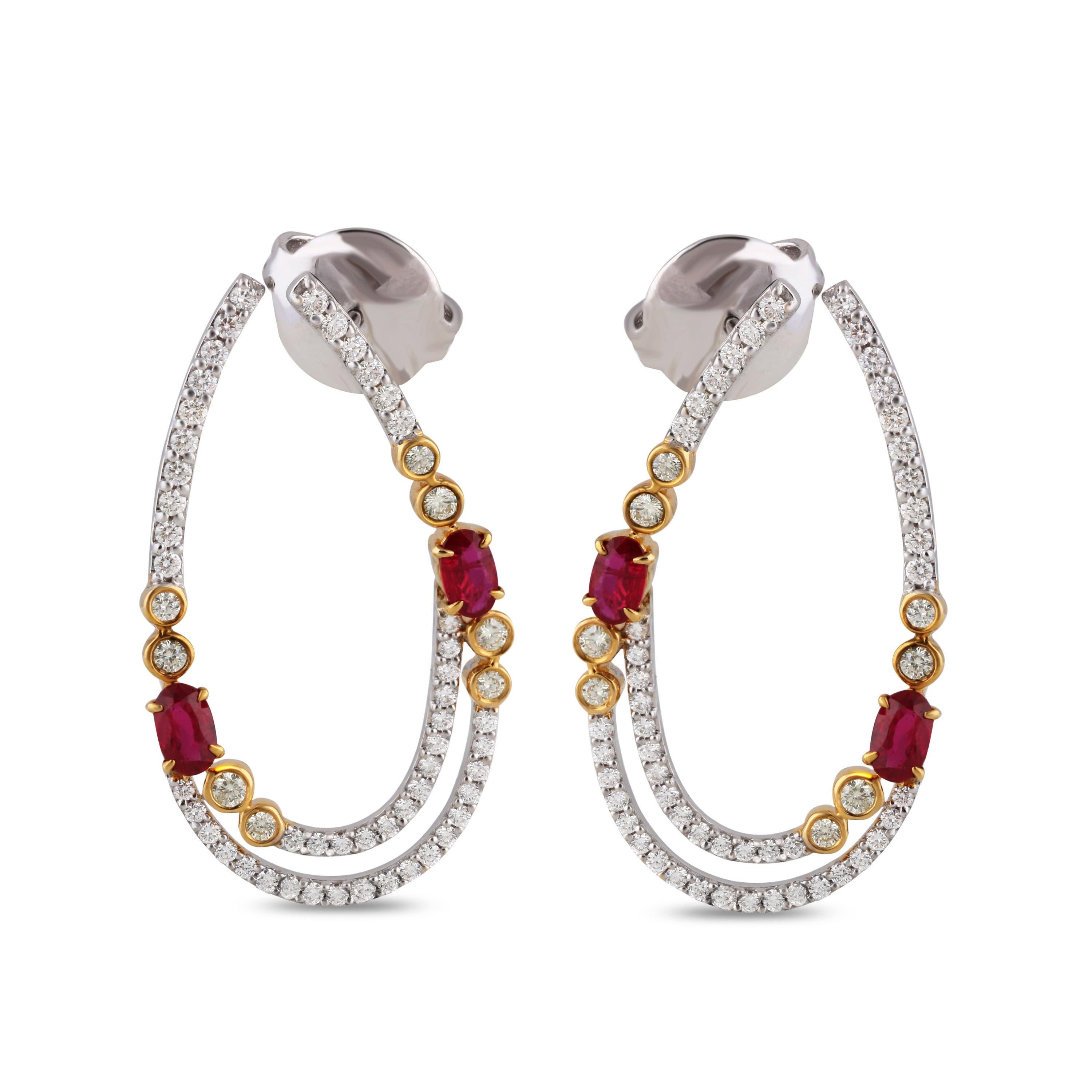 Elegant diamond hoops are accentuated by contrasting oval cut rubies flanked by yellow diamonds in a bezel setting of 18 karat yellow gold. Stylish and versatile, these hoops coordinate perfectly with both daytime and evening wear.

Video of the
