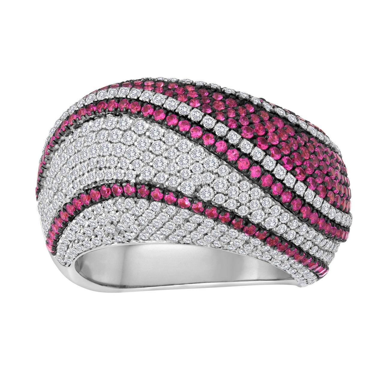This piece consists of multiple rows of rubies and white diamonds, arranged in an elegant wave-like pattern. The total weight of the sapphires is 1.43 cts. The total weight of the diamonds is 1.25 cts.  All stones are pave set in 18k white gold.