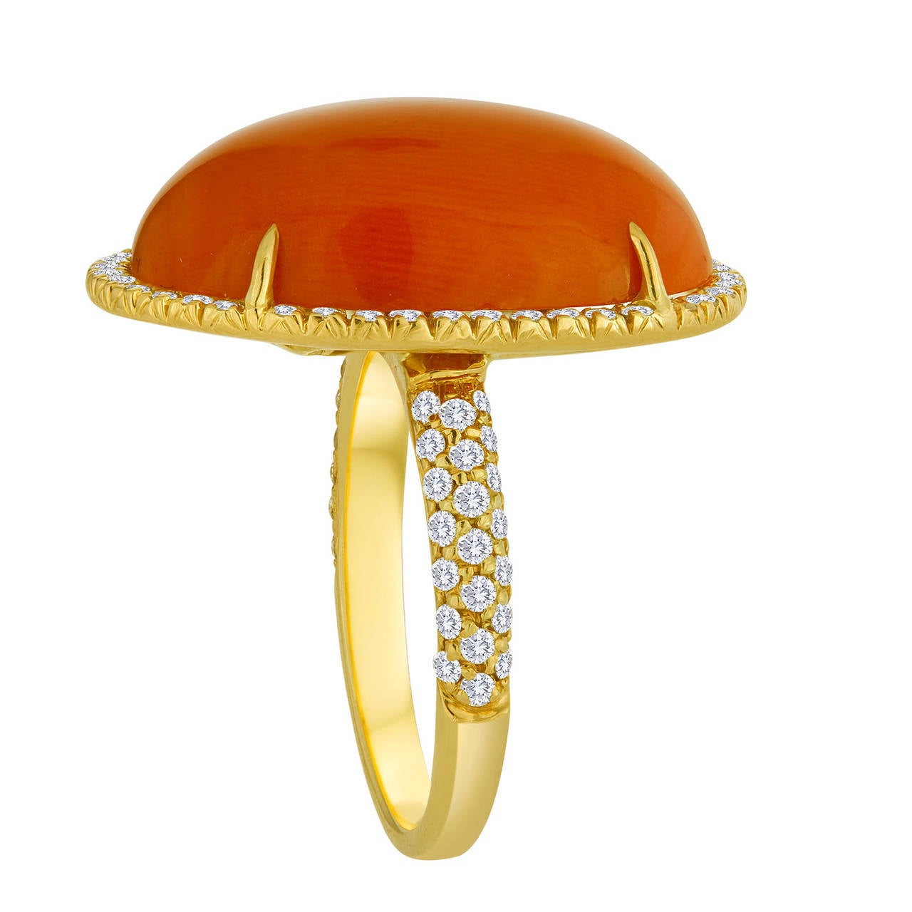 This simple ring displays an oval cabochon coral center stone that is prong-set in an 18k yellow gold setting. Surrounding the coral is a row of pave white diamonds, along with a series of white diamonds that run halfway down the shank of the ring.