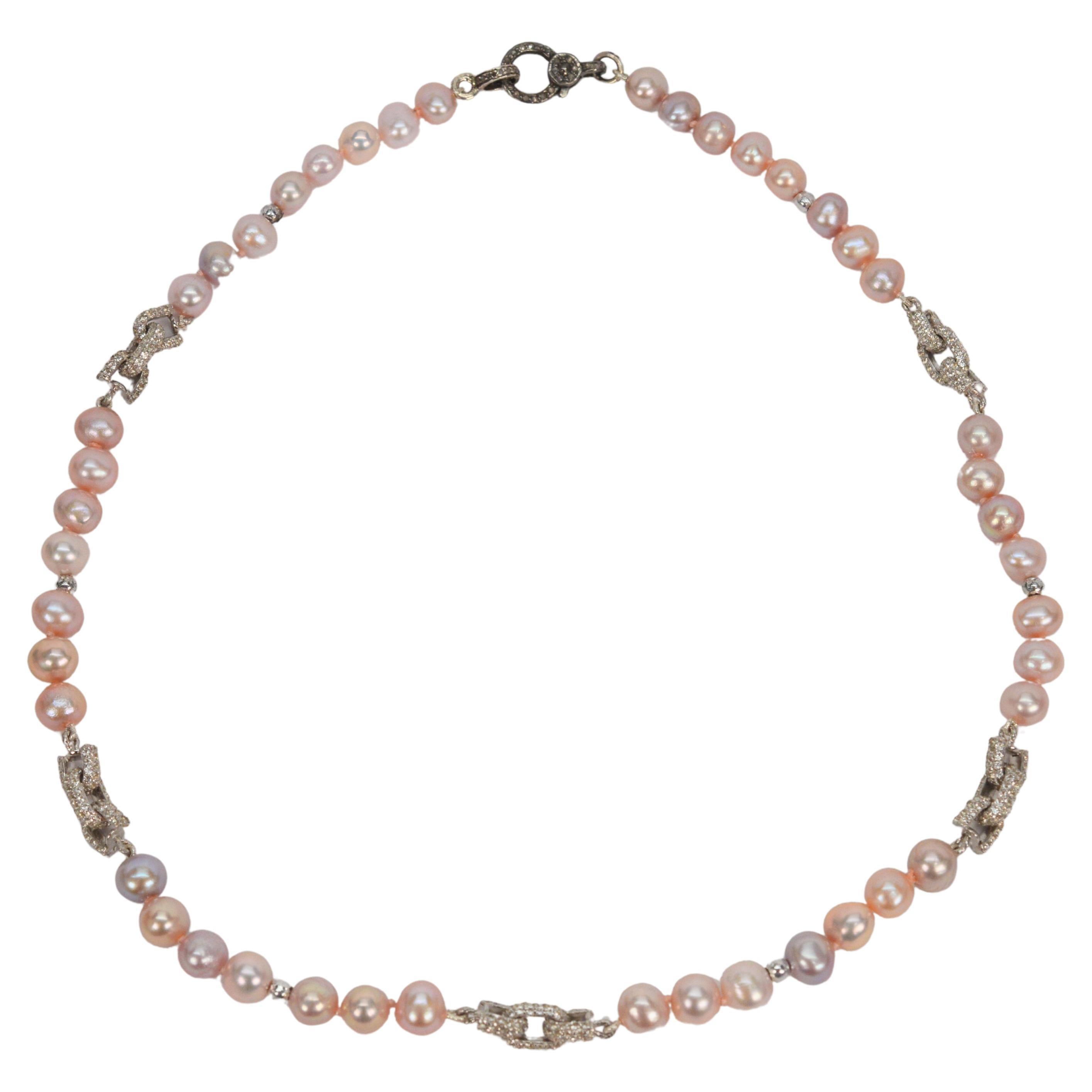 Ultra-feminine with a mix of soft warm blush hues, hand-strung 6.5mm akoya pearls are enhanced by five fabulous white sapphire sterling bow-tie inspired link stations that sparkle along this 16 inch strand. 
Artisan made, one-of-a-kind, fitted with
