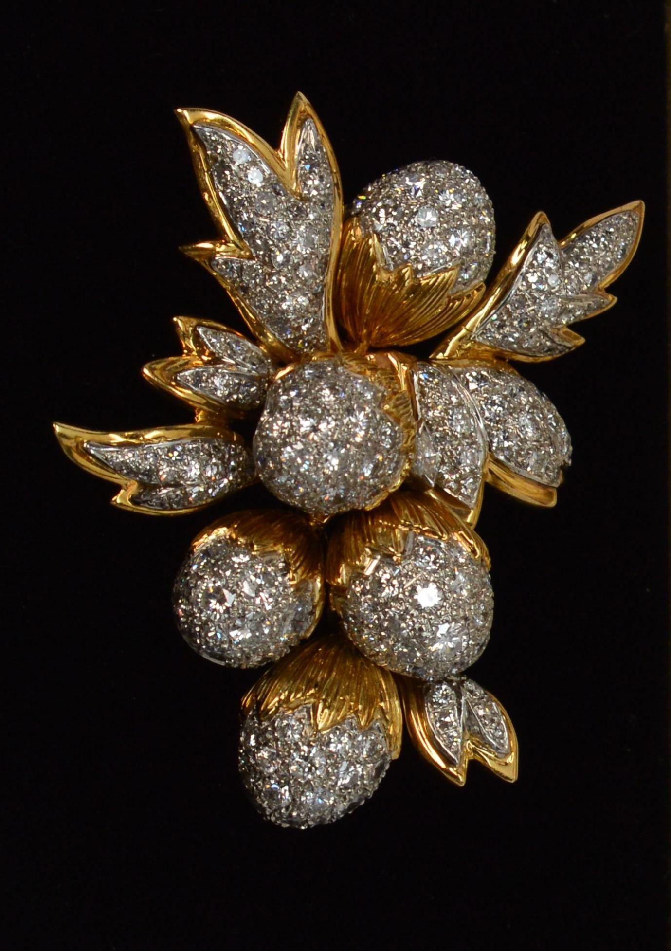 Fabulously designed circa 1950's, this diamond encrusted handmade custom brooch is a truly stunning estate piece! A symbol of strength and potential, the acorn spray is made of brilliant eighteen karat 18k yellow gold and platinum and is covered