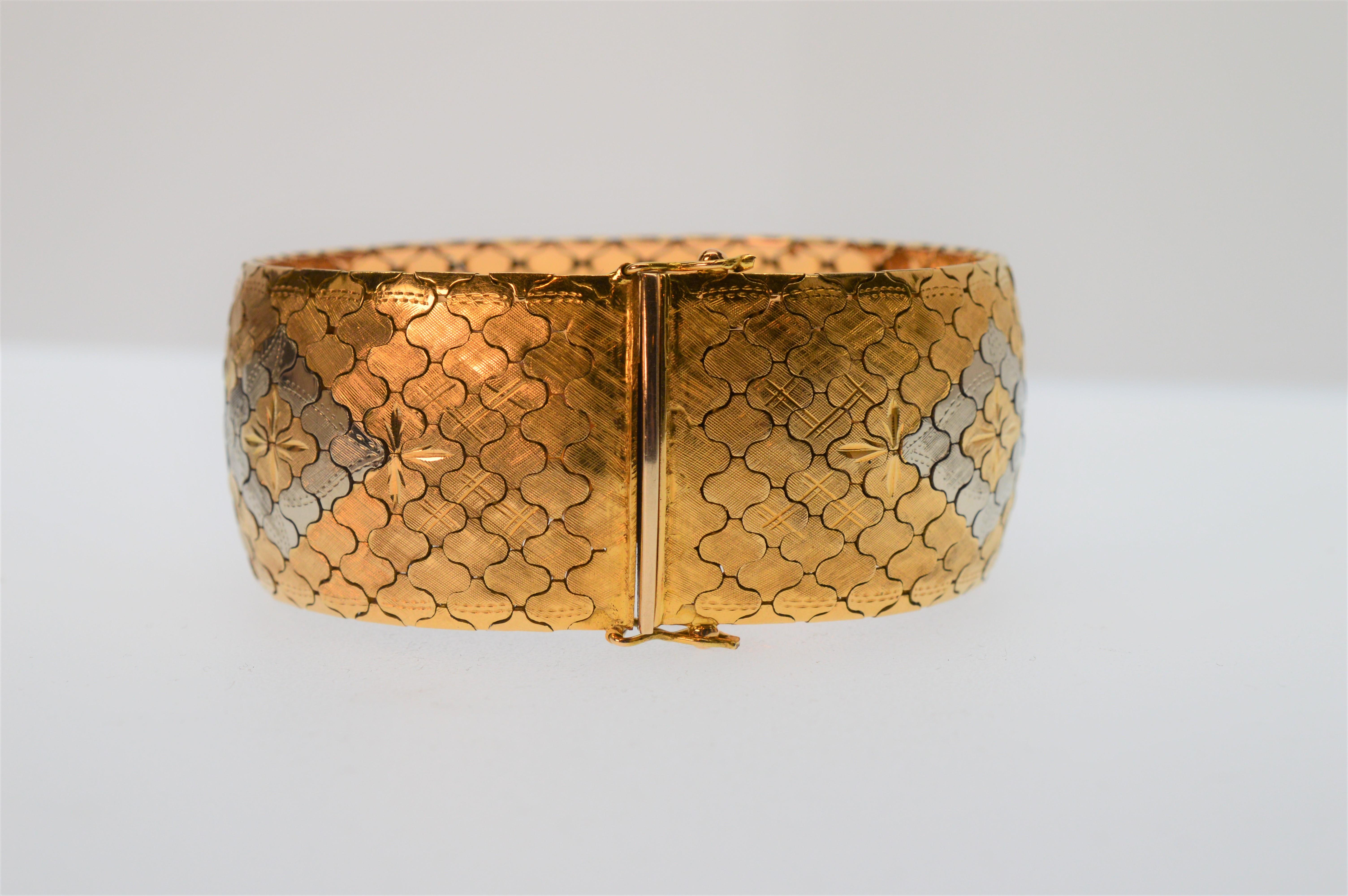 Intriguing and bold, this eighteen karat (18k) gold bracelet is expertly crafted with an intricate pattern of yellow, white and rose gold creating a multi-color unique geo floral design. Italian made, the links are fashioned in such a way that the