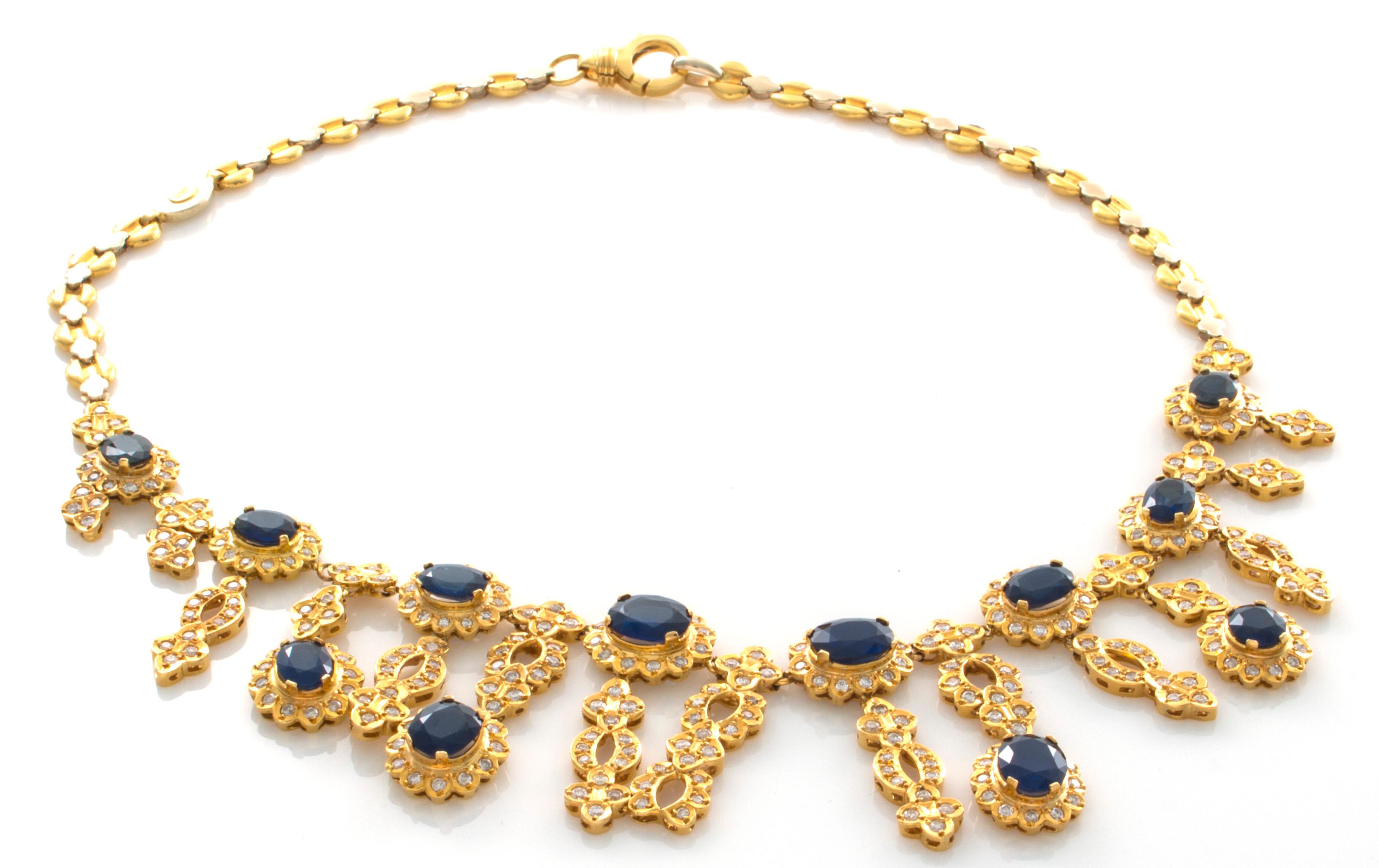 18 Karat Yellow and White Gold 30.48 Carat Sapphire and 6.80 Carat Diamond Necklace. The necklace has a bright polished finish with the front featuring a series of eight, graduated cut sapphires, each within a circular diamond frame. The clusters