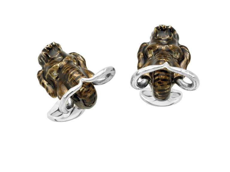 Sterling silver woolly mammoth cufflinks with a brown enamel finish and diamond eyes.
