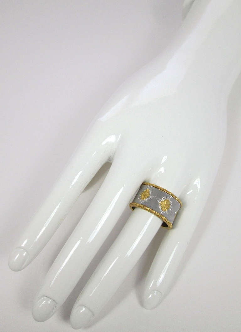 A textured 18k yellow and white gold band ring

Weight: 8.1 gr

Band width: 12.5 mm

Finger size: 8

Signed Buccellati, Italy

PLEASE NOTE: OUR PRICE IS FULLY INCLUSIVE OF SHIPPING, IMPORTATION TAXES & DUTIES