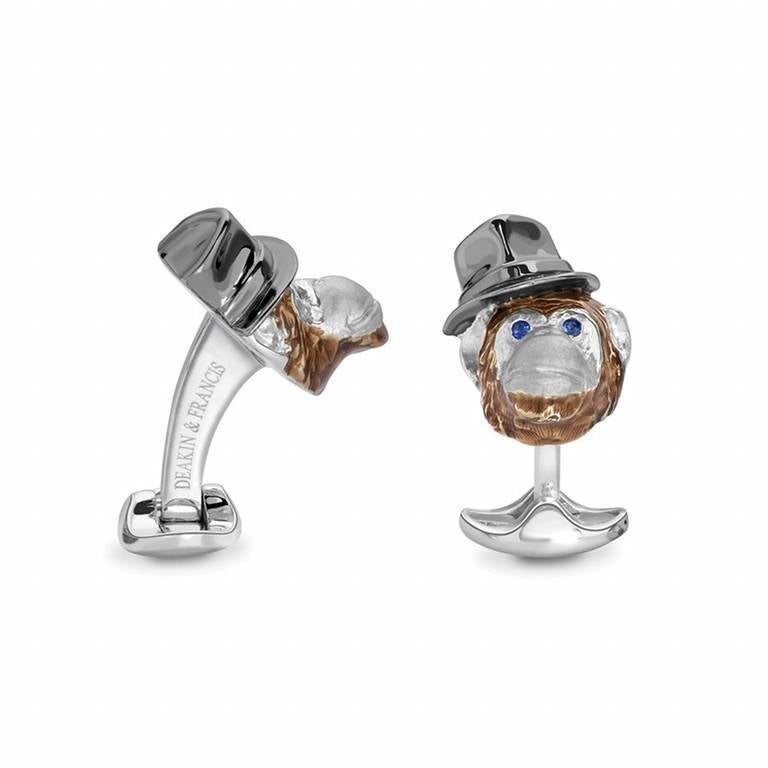 PLEASE NOTE: OUR PRICE IS FULLY INCLUSIVE OF SHIPPING, IMPORTATION TAXES & DUTIES.
These sterling silver Chimpanzee with Hat Cufflinks are enamelled in brown and metallic grey and set with sapphire eyes. Part of the Safari Collection.

Complete with
