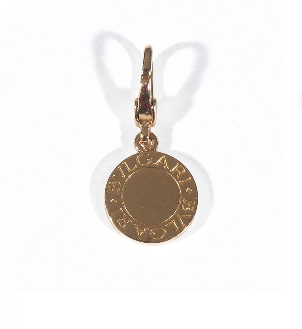 PLEASE NOTE: OUR PRICE IS FULLY INCLUSIVE OF SHIPPING, IMPORTATION TAXES & DUTIES

The round pendant centrally pave set with brilliant cut diamonds on one side and the inscription Bulgari on both sides

Mounted in 18Kt yellow gold

Signed