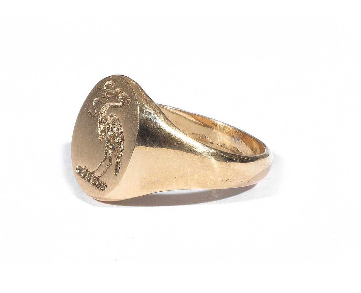 A small yellow gold signet ring, the top engraved with a stork holding a snake in the beak. This very old iconography indicates, for the Judeo-Christian tradition, Christ slaying the demon and, more generally, that the Good wins over