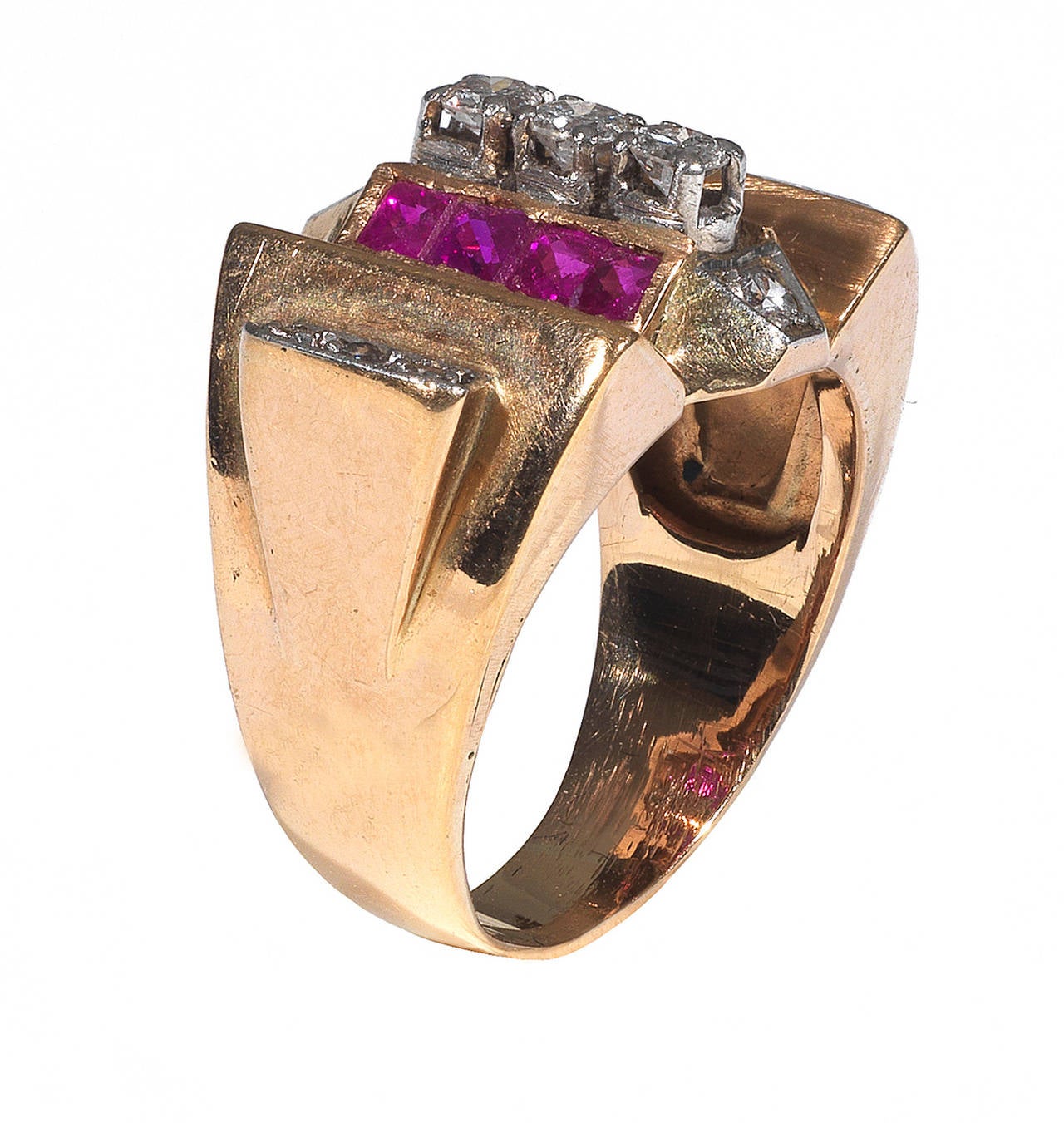 
An unusual retro ring made of three sections, the central one with claw and collet set diamonds and six collet set square cut rubies, the two side sections each with three collet set diamonds.

Mounted in 18Kt rose gold and platinum.

Size: 6