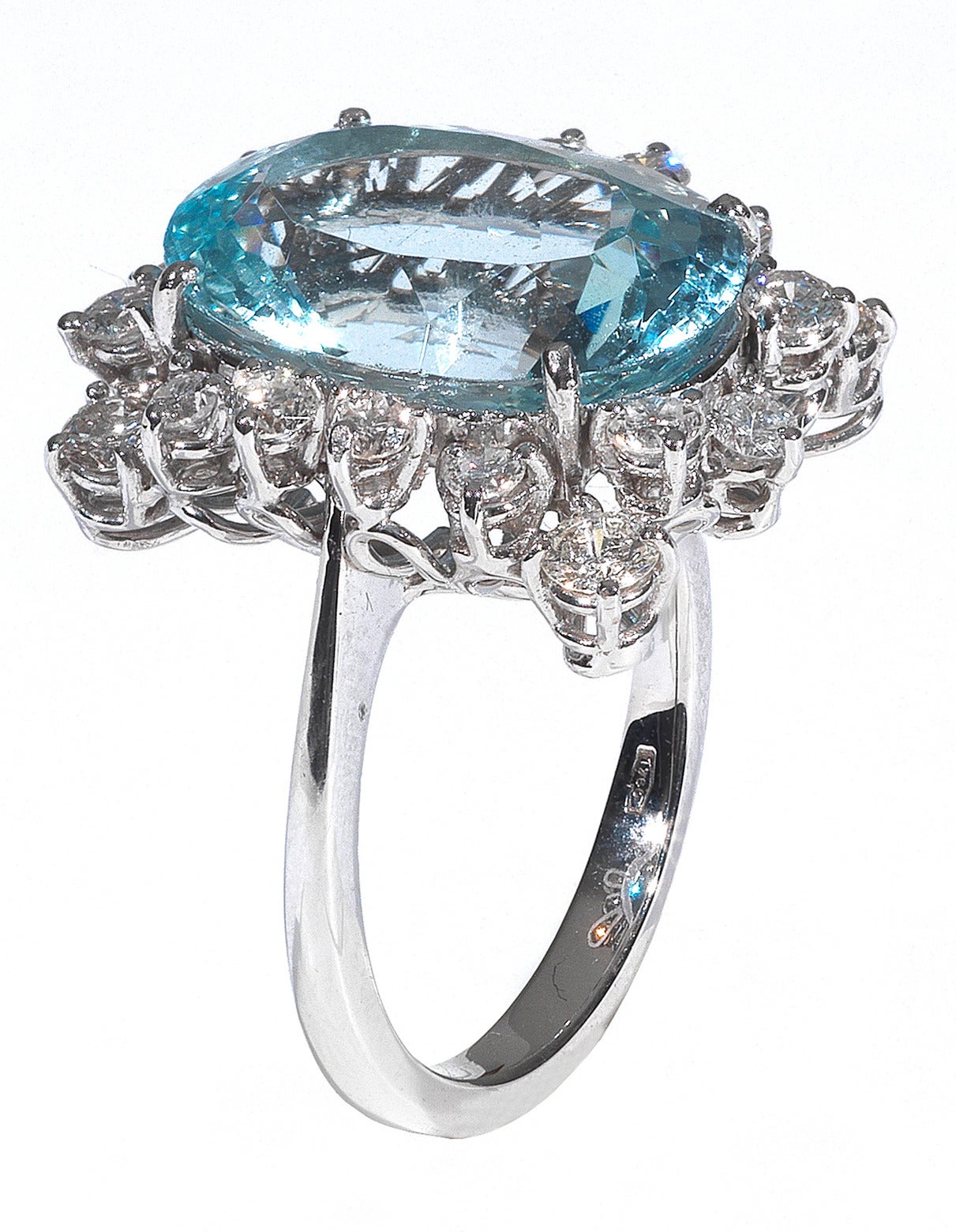 Claw-set with an oval shape mixed-cut aquamarine weighing 9 cts, bordered by a brilliant-cut diamond frame.

The diamonds weighing 1.25 cts

Mounted in 18Kt white gold

Finger size: 6.5

Weight: 8.8 gr