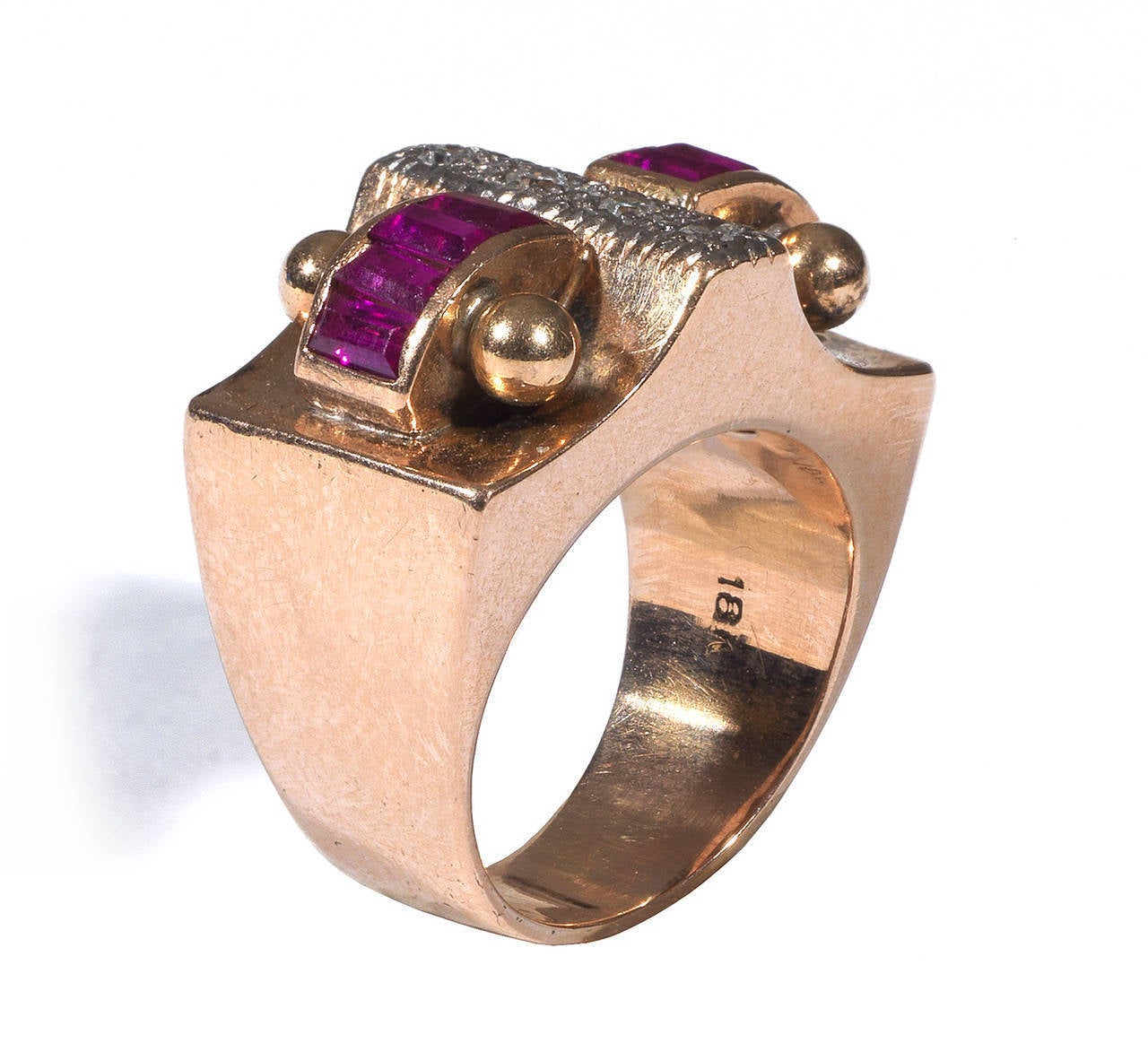 A retro ring designed with at the centre a platinum section set with four diamonds, at the sides four calibre cut rubies bordered by four balls, to a plain hoop.

Mounted in 18Kt rose gold and platinum.

Size: 6 1/2
Weight: 10.1 gr