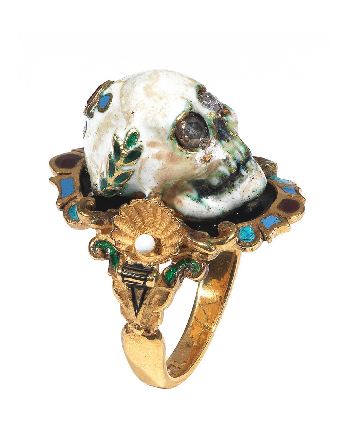

Renaissance style Memento Mori skull ring made with champleve multicolored enamels, rose cut diamonds eyes and square shape collet set ruby.

Mounted in 18Kt gold

Signed A. Codognato Venezia

Weight: 14.7 gr

Finger size: 8