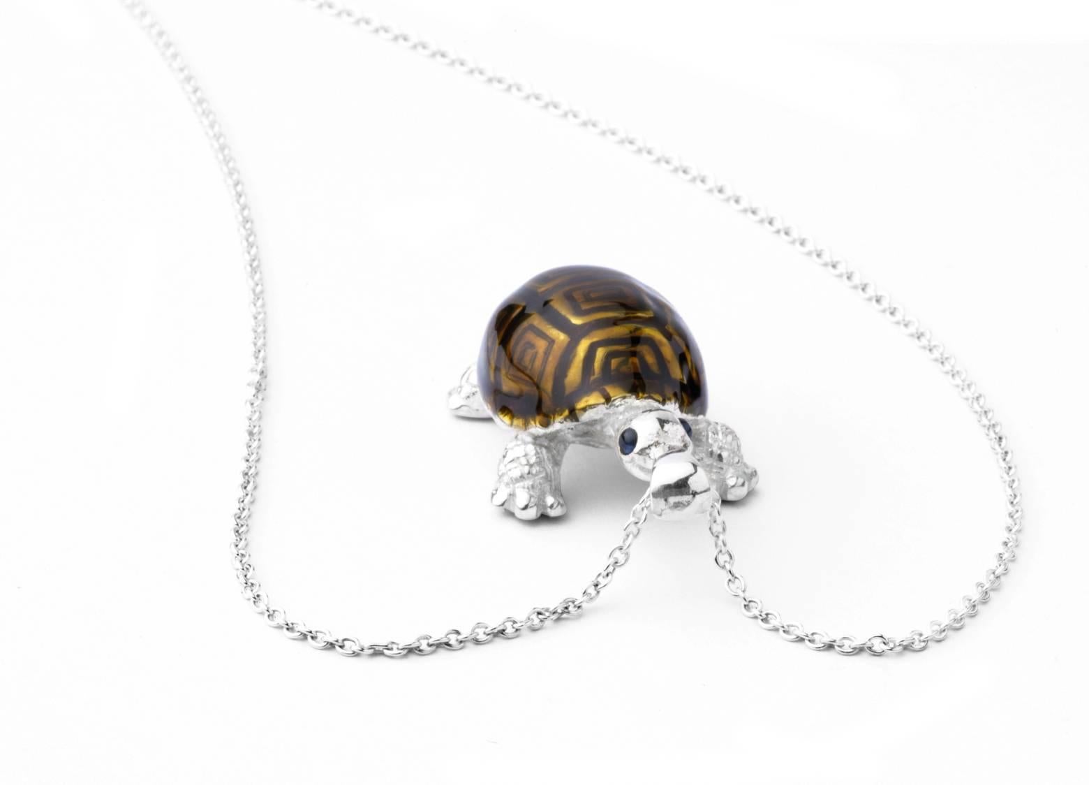 The sterling silver tortoise pendant has a brown enamel finish and is fitted on to a 15