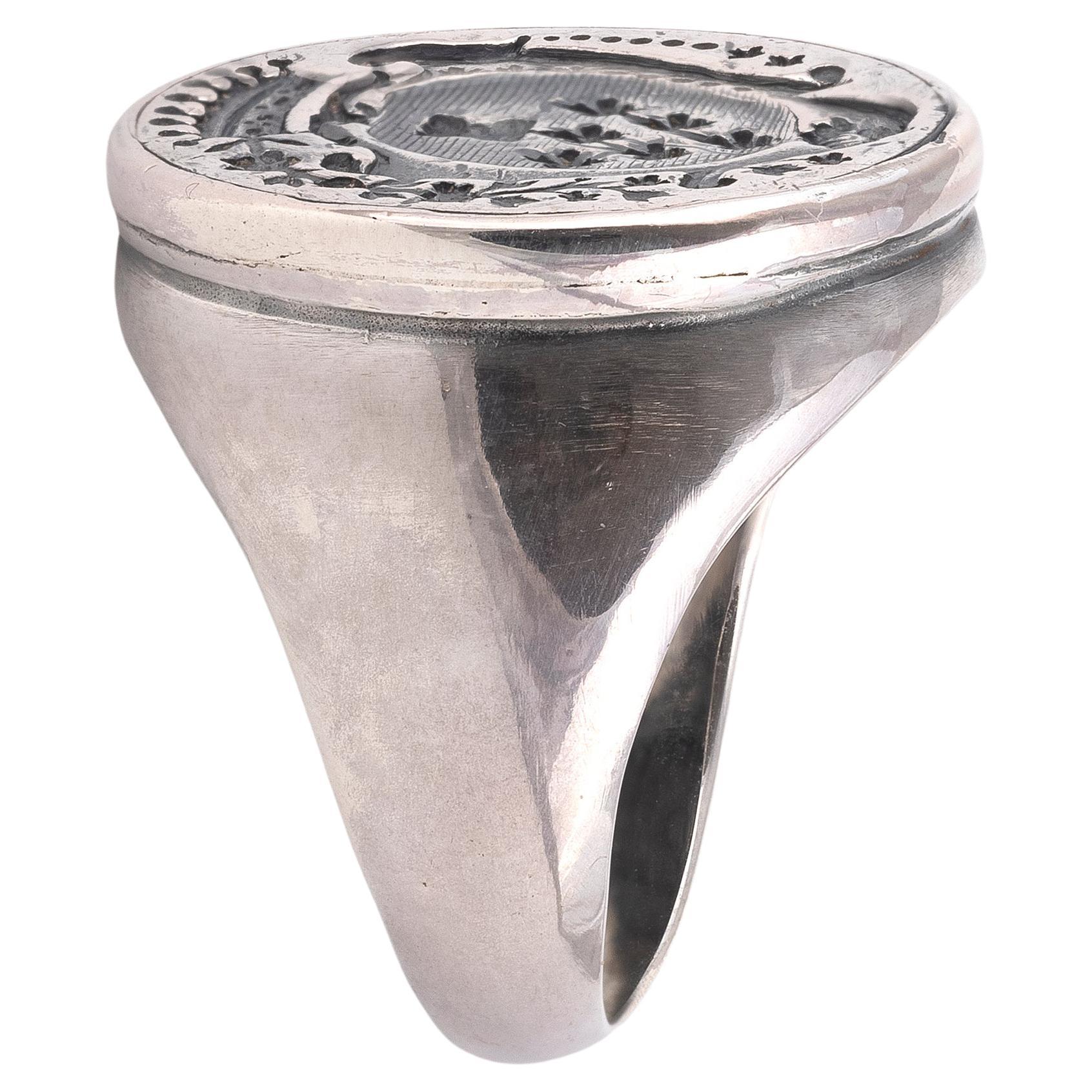 The ring has a great face that was probably at one time an official seal with extremely intricate detail that flows from top to bottom.The overall approximate face dimensions are 24mm tall by 20mm wide. Ring is approximately a size 9 on my ring