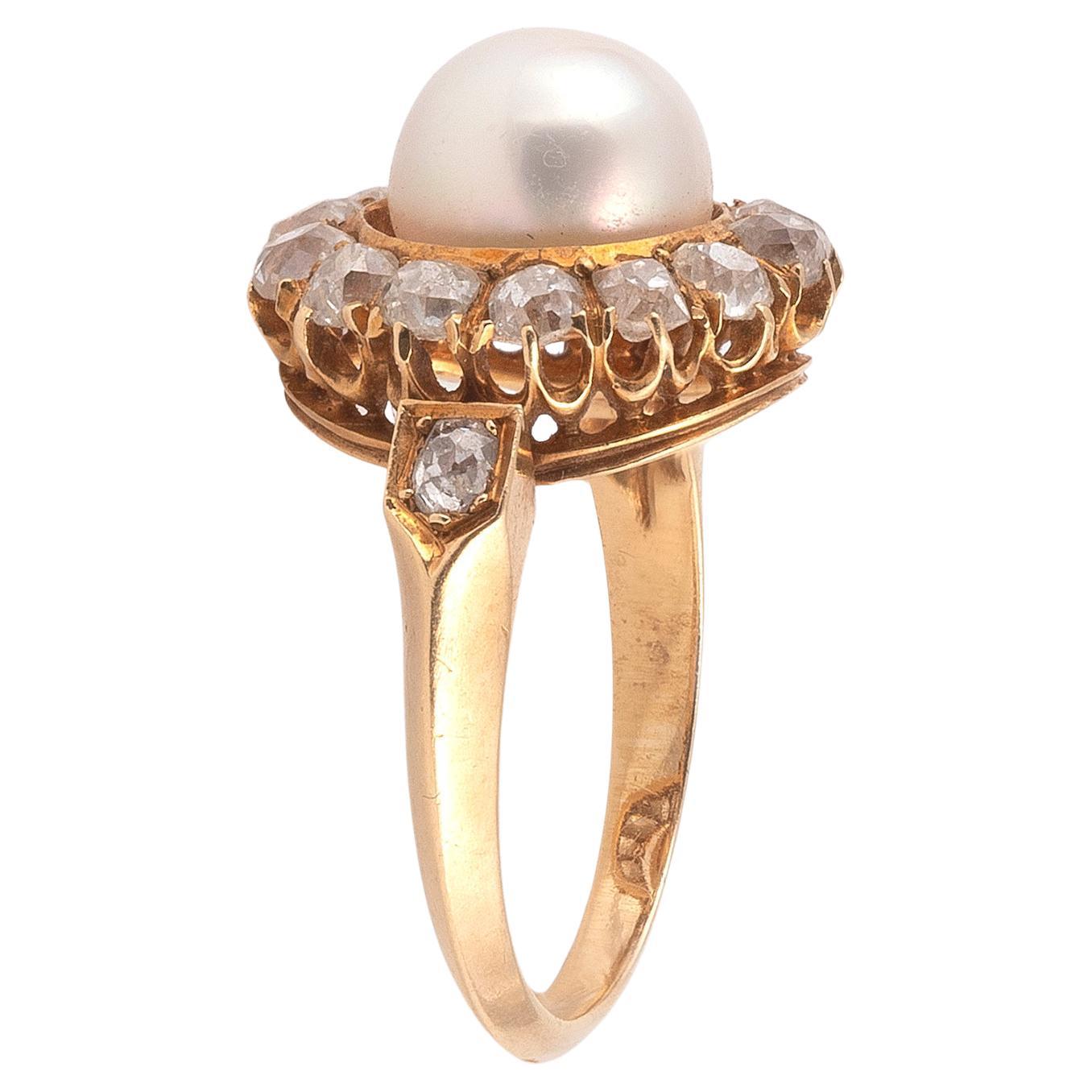 

Centering on a natural pearl within old cut diamond set frame, diamond set shoulders, mounted in gold, circa 1890
US ring size 7
Diamond Approximate total weight of 0.60 carats
Pearl Measuring approximately 7.8 mm
Marks French gold marks
Gross