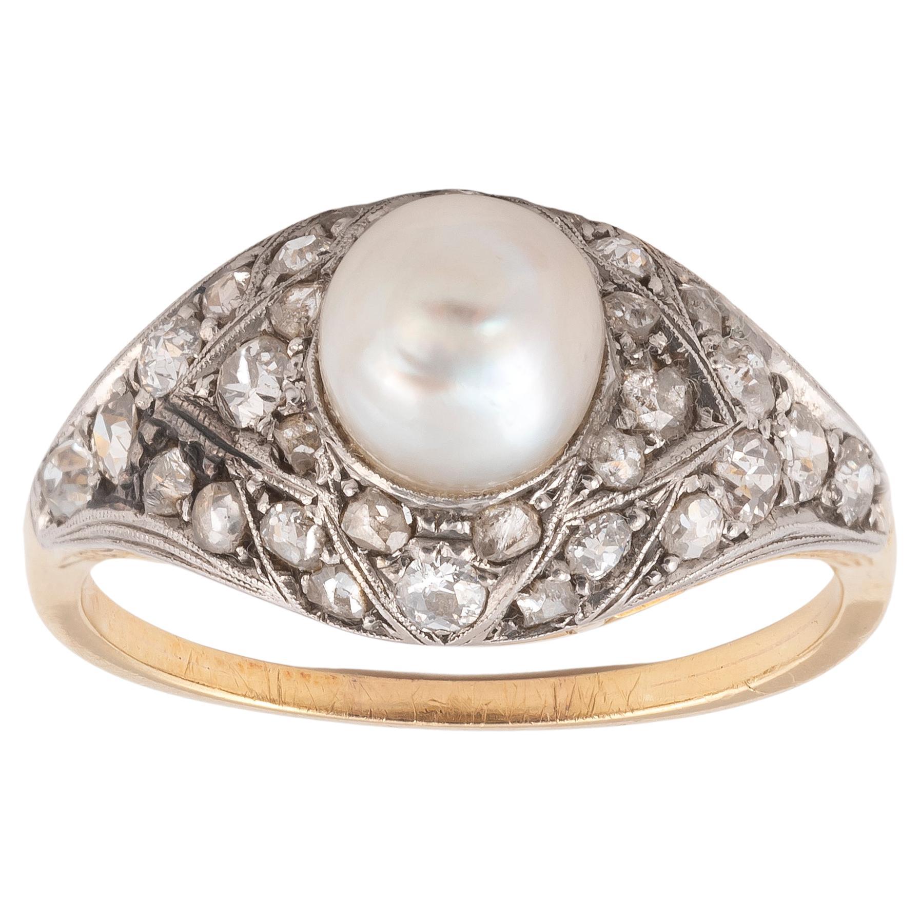 

Of bombé design, centred with a single pearl within a pierced surround of old and single-cut diamonds, ring size 8 3/4
Weight:  4.45gr.
