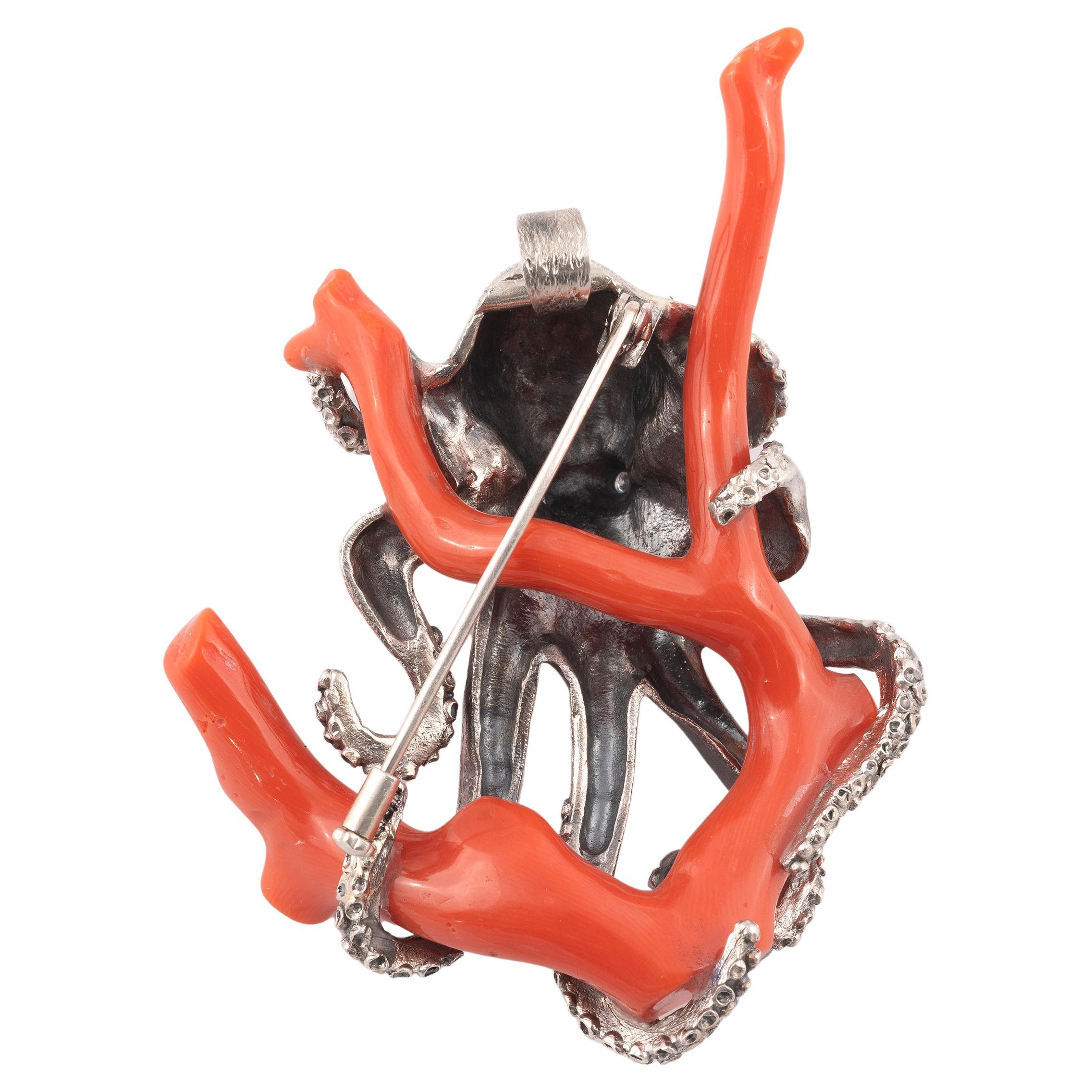 
The octopus eyes set with 2 round diamonds, coiled around a coral branch, mounted in silver.

Lenght 7cm (2.8in)