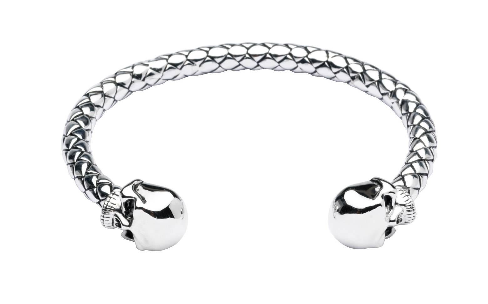 PLEASE NOTE: OUR PRICE IS FULLY INCLUSIVE OF SHIPPING, IMPORTATION TAXES & DUTIES

The silver skull bangle is made from solid sterling silver, which have been oxidised to create its darker tone. This torque style bangle is self adjustable, simply