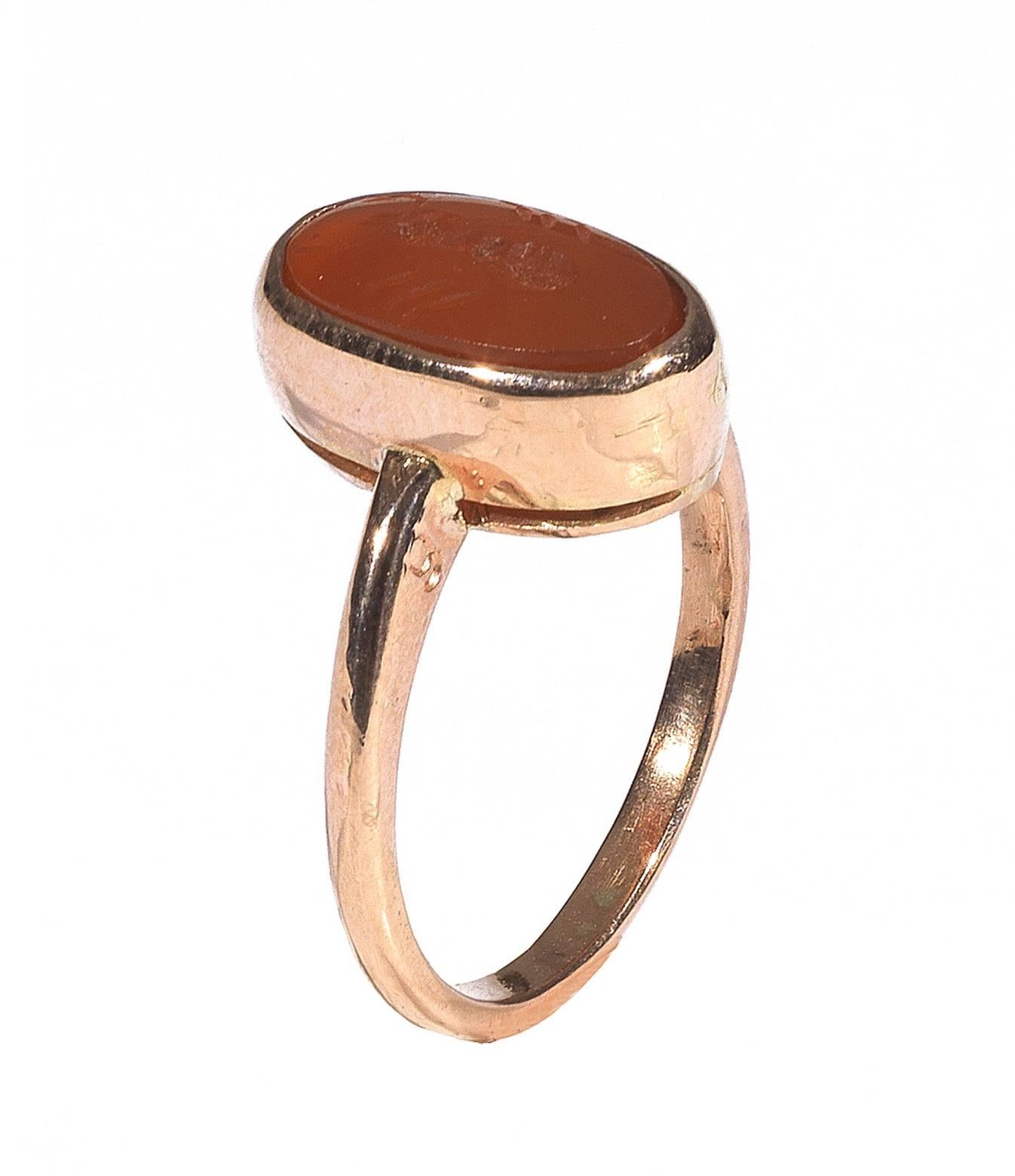 The oval stone engraved with a stylized ant. Mounted as a ring in a gold setting.

Size 7 

Weight: 2.6 gr