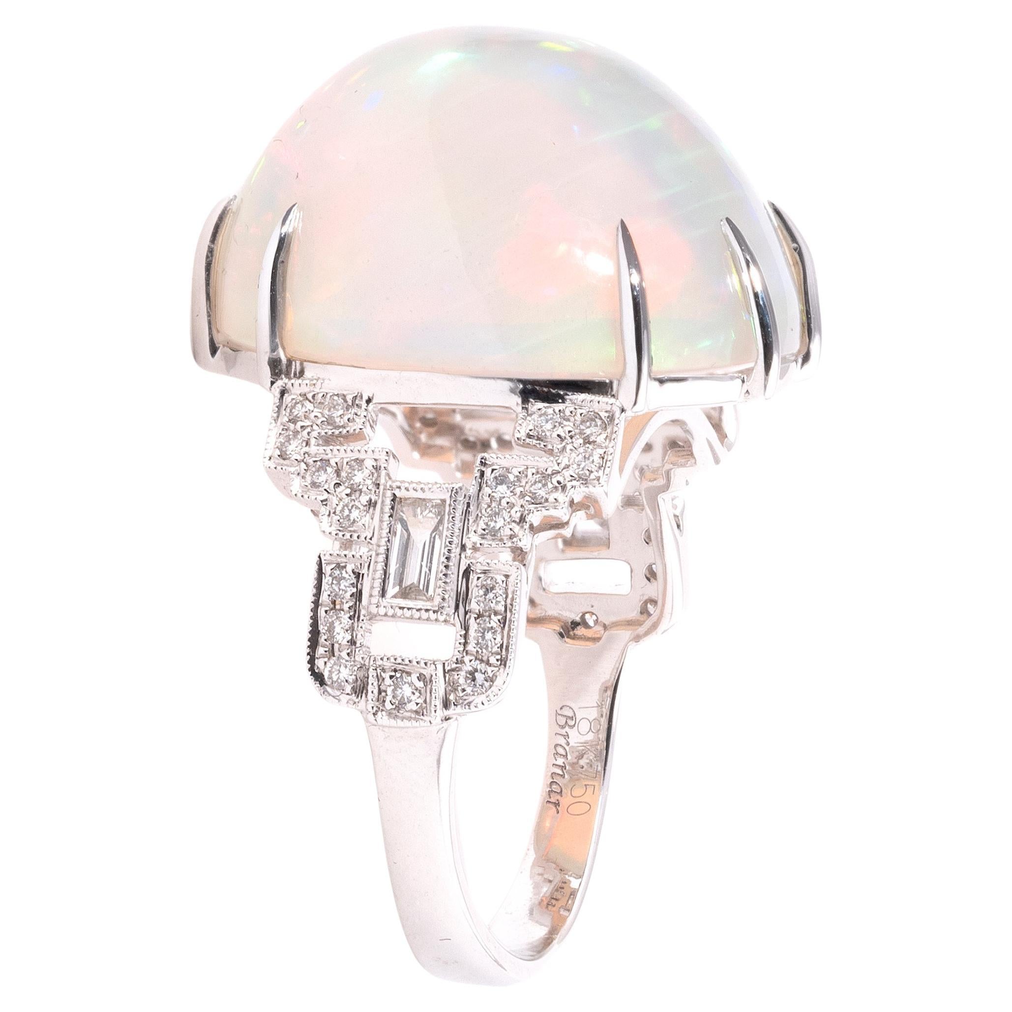Ring in 750°/°°(18K) white gold, set with a beautiful oval cabochon opal weighing approx. 15 ct, openwork shoulder set with baguette and brilliant-cut diamonds.
Weight  7,2gr.
Size: 6 1/2
Length: 1.9 cm. 
