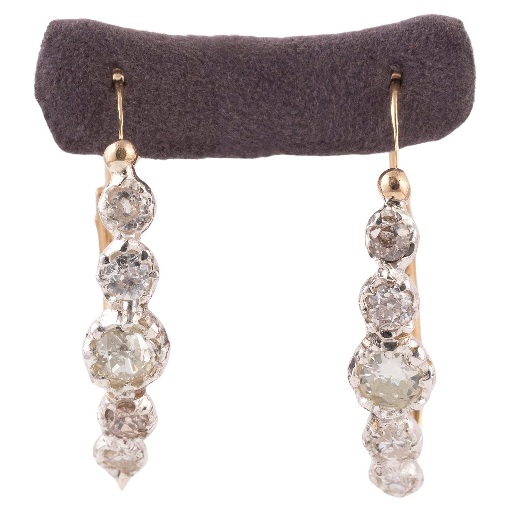 Poissarde earrings with old cut diamonds approximately 4ct in silver and gold. Typical back to front ear fittings of the poissarde style and wig loop. European in origin, circa 1830circa
Height: 3.5cm. Gross weight: 7.9 g.