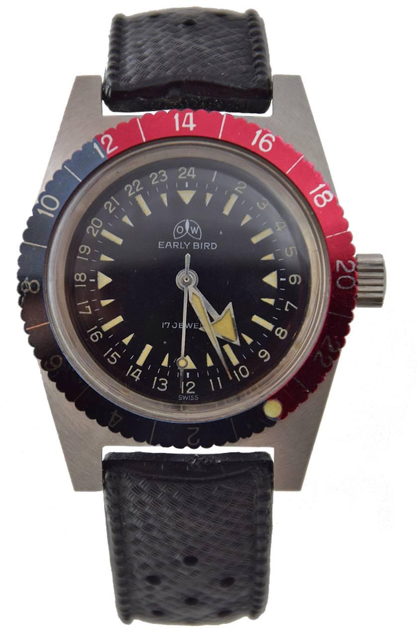 

Made in the second half 1960s.

Case:
three-body, tonneau-shaped, brushed and polished, revolving red and blue 24-hour bezel, screw-down case back, thick domed crystal.

Dial:
black with luminous baton and triangular indexes, outer 24-hour