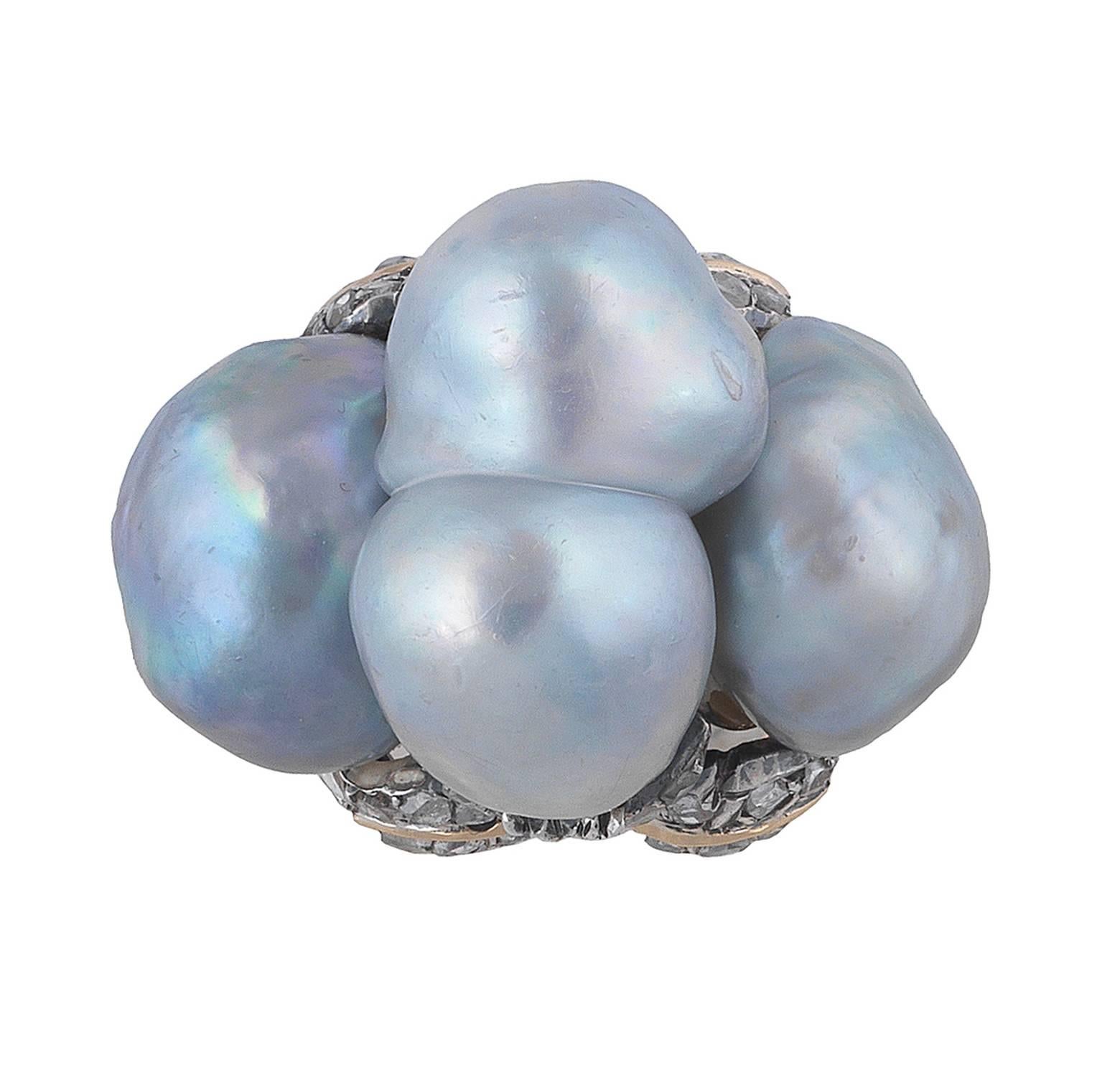 PLEASE NOTE: OUR PRICE IS FULLY INCLUSIVE OF SHIPPING, IMPORTATION TAXES & DUTIES.

Designed as a dome featuring three grey baroque pearls measuring approx. 17 x 10 mm (the central one) and 12 x 10 mm (the two at the sides) to a stylized flowers
