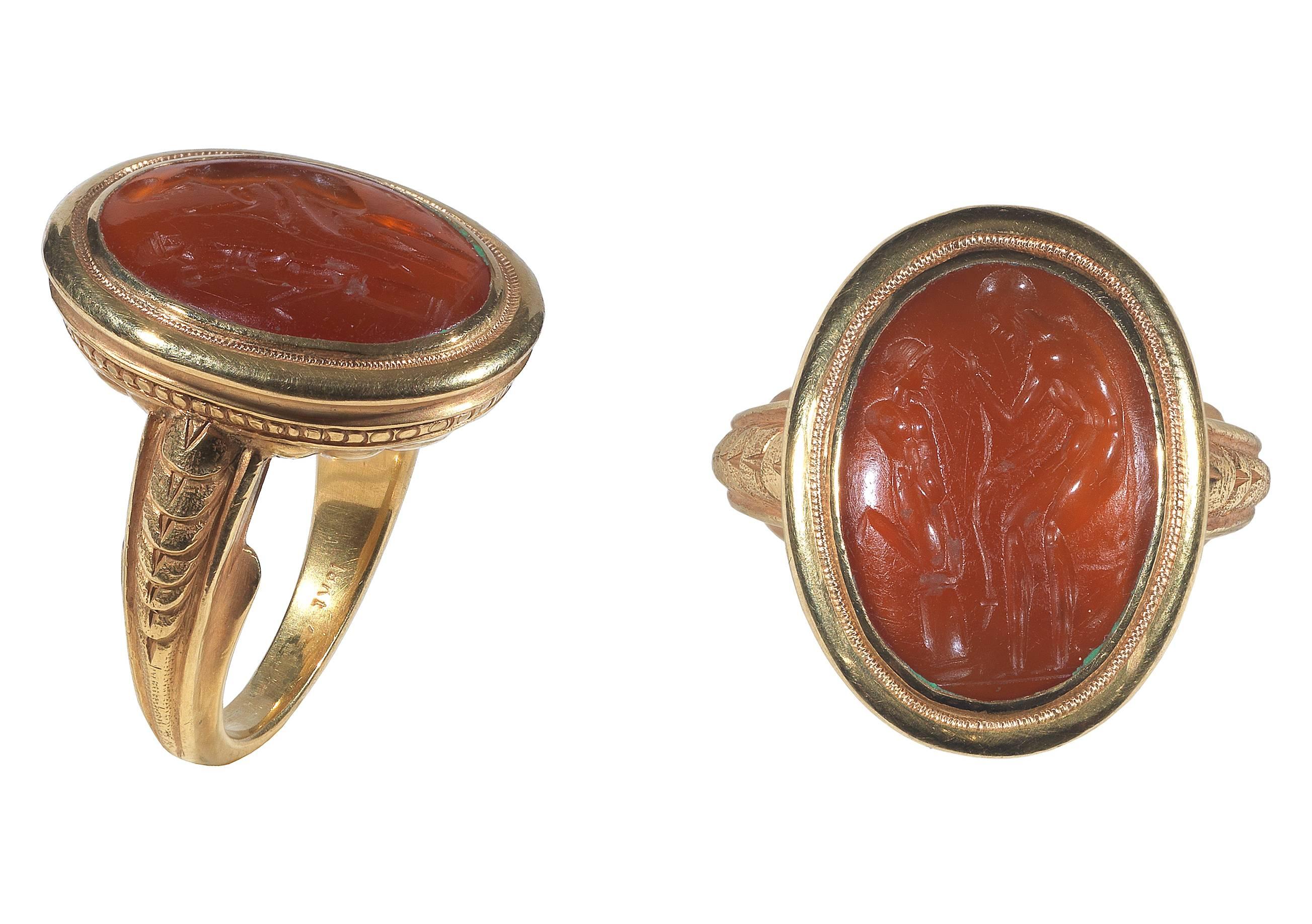 
BERNARDO ANTICHITÀ PONTE VECCHIO FLORENCE
The 2nd century BC oval carnelian carved to depict a sculptor measuring an unfinished statue.

The 18Kt yellow gold archaeological style setting with with shell top and engraved shoulders.

Measurements of