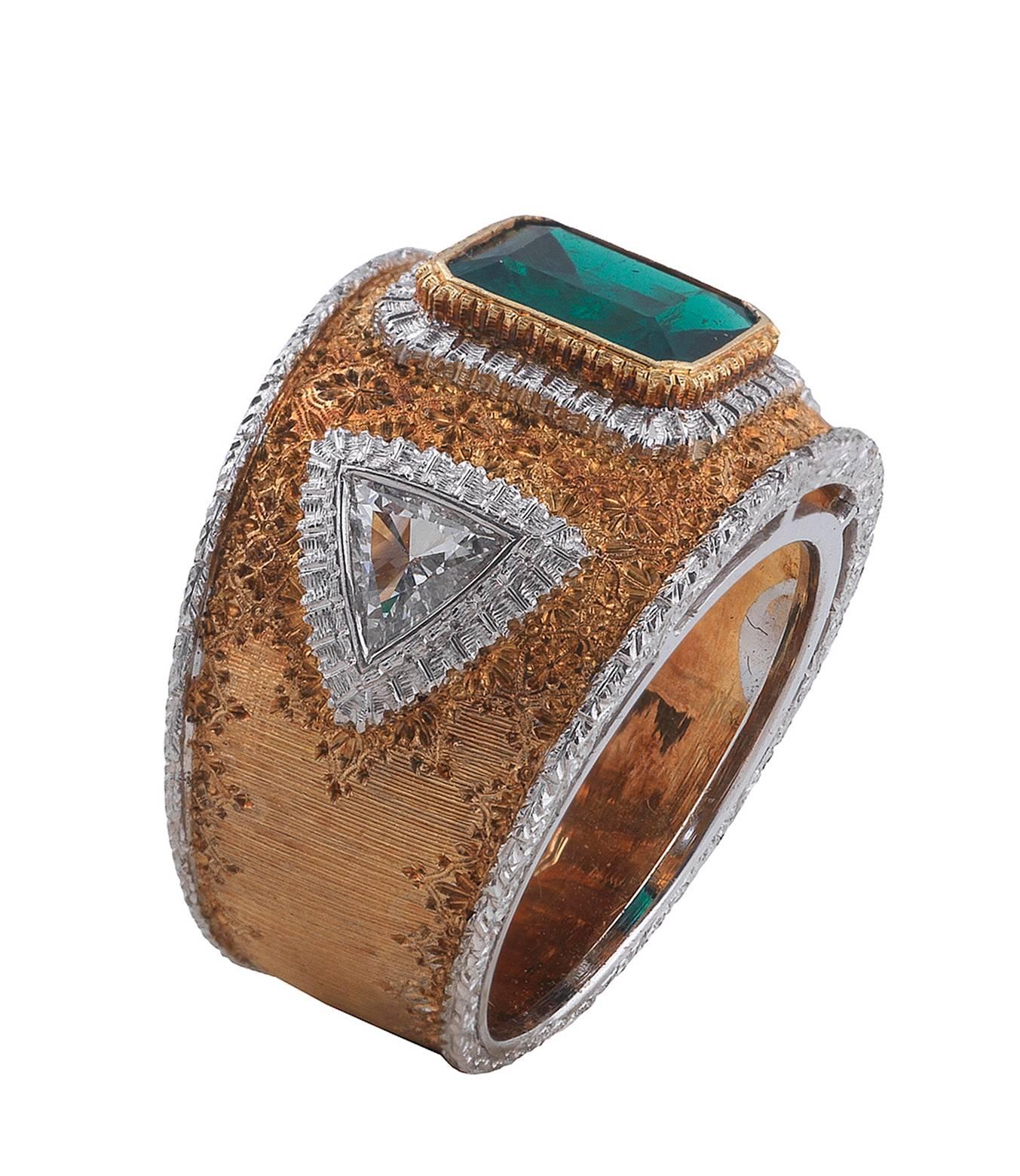 
PLEASE NOTE: OUR PRICE IS FULLY INCLUSIVE OF SHIPPING, IMPORTATION TAXES & DUTIES.

Designed as a textured rose gold wide band finely pierced with at the centre a collet set octagonal-cut emerald weighing approx. 2 cts, at the shoulders two