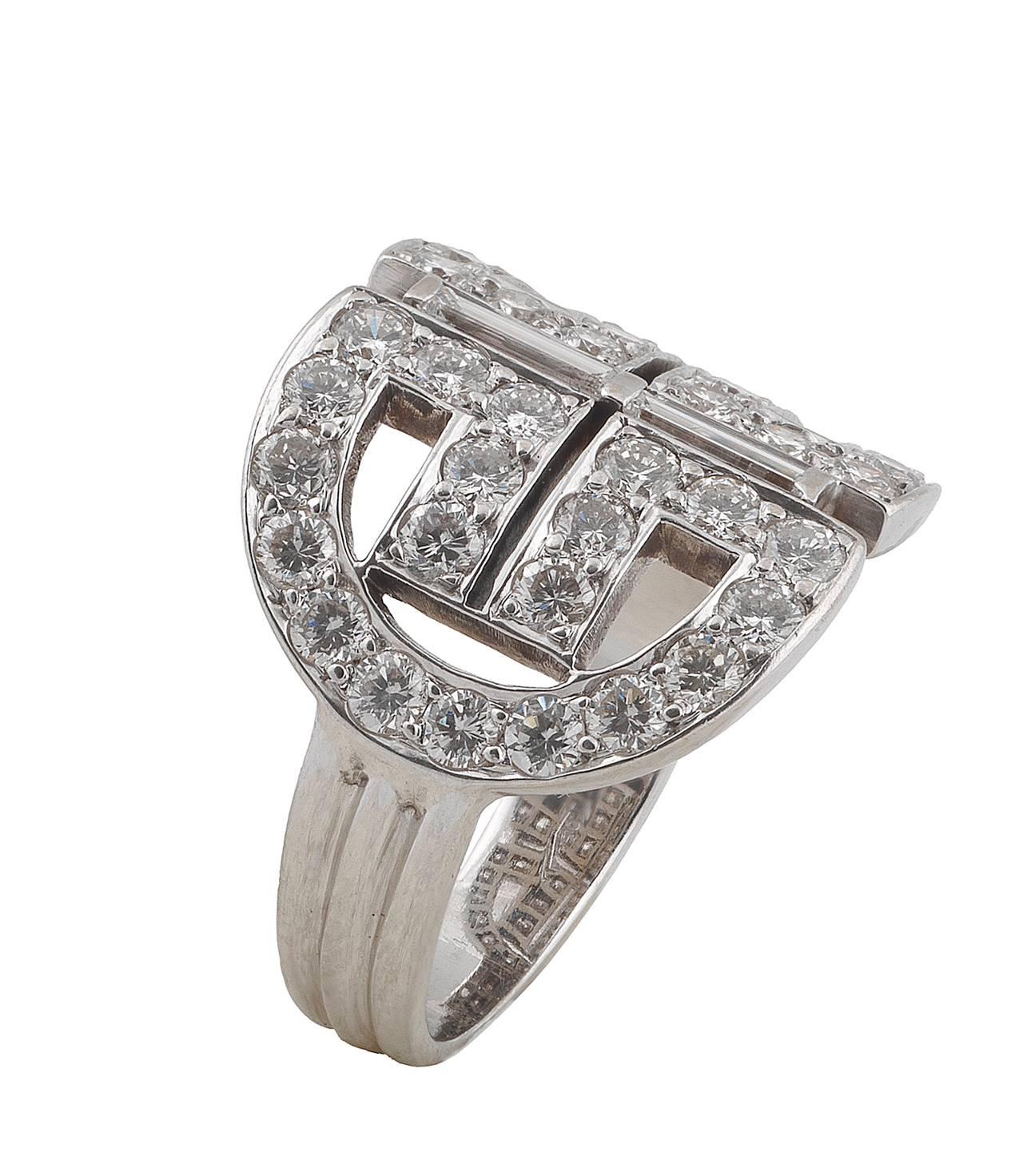 Designed with a geometric pattern, claw set brilliant cut diamonds weighing approximately 2 cts, two collet set baguette cut diamond weighing approximately 0.60 cts

Mounted in 18Kt white gold.

Finger size: 8

Weight: 9.4 gr
