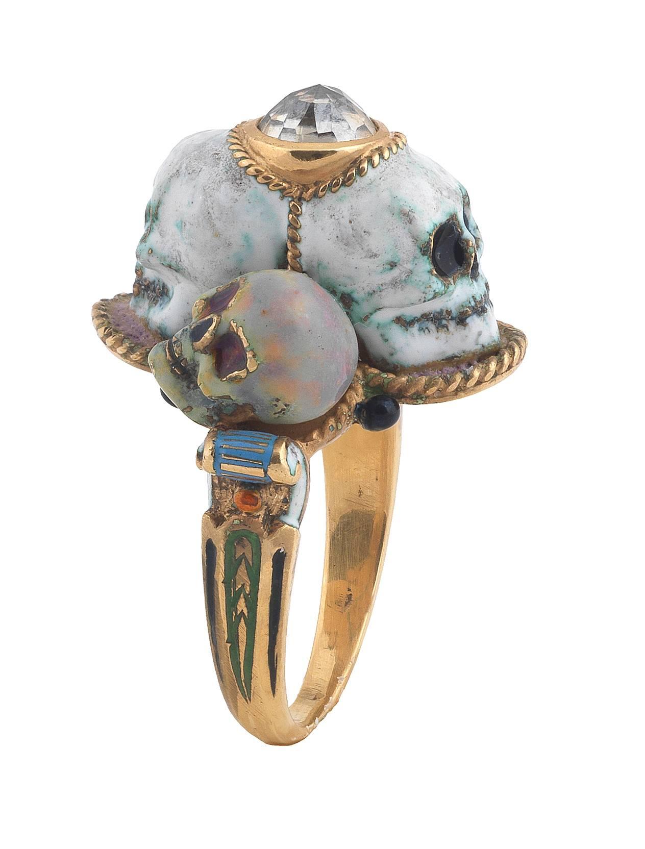 PLEASE NOTE: OUR PRICE IS FULLY INCLUSIVE OF SHIPPING, IMPORTATION TAXES 
DUTIES.

The bezel designed with four skulls, the double face centre one set with a rose gold diamond, the others two facing opposite directions. 

All the ring decorated