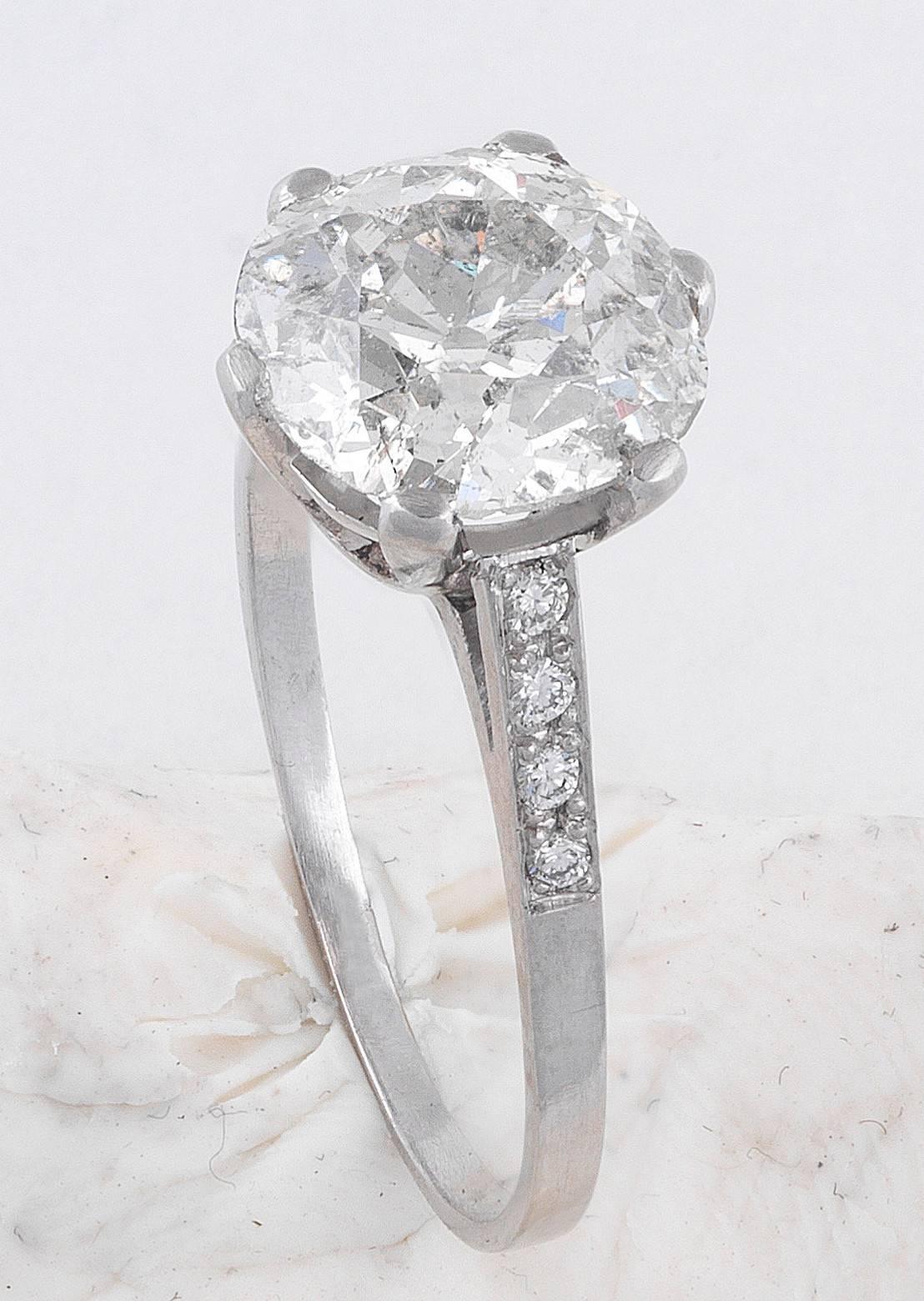 PLEASE NOTE: OUR PRICE IS FULLY INCLUSIVE OF SHIPPING, IMPORTATION TAXES & DUTIES.

c. 1905 England

An old cut cushion cut diamond ring weighing 3.08ct, I SI2. Mounted in platinum in a four split claw setting with cut diamond set
