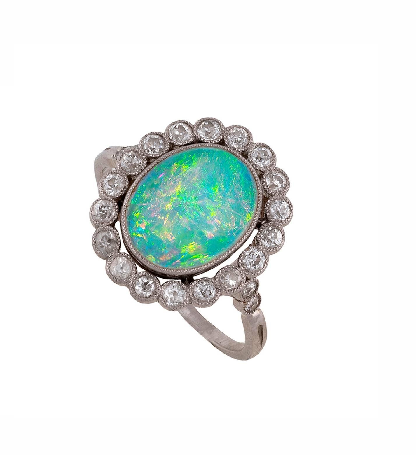 
The central oval-shaped black opal within old-cut diamond surround to the plain hoop 
Size 7