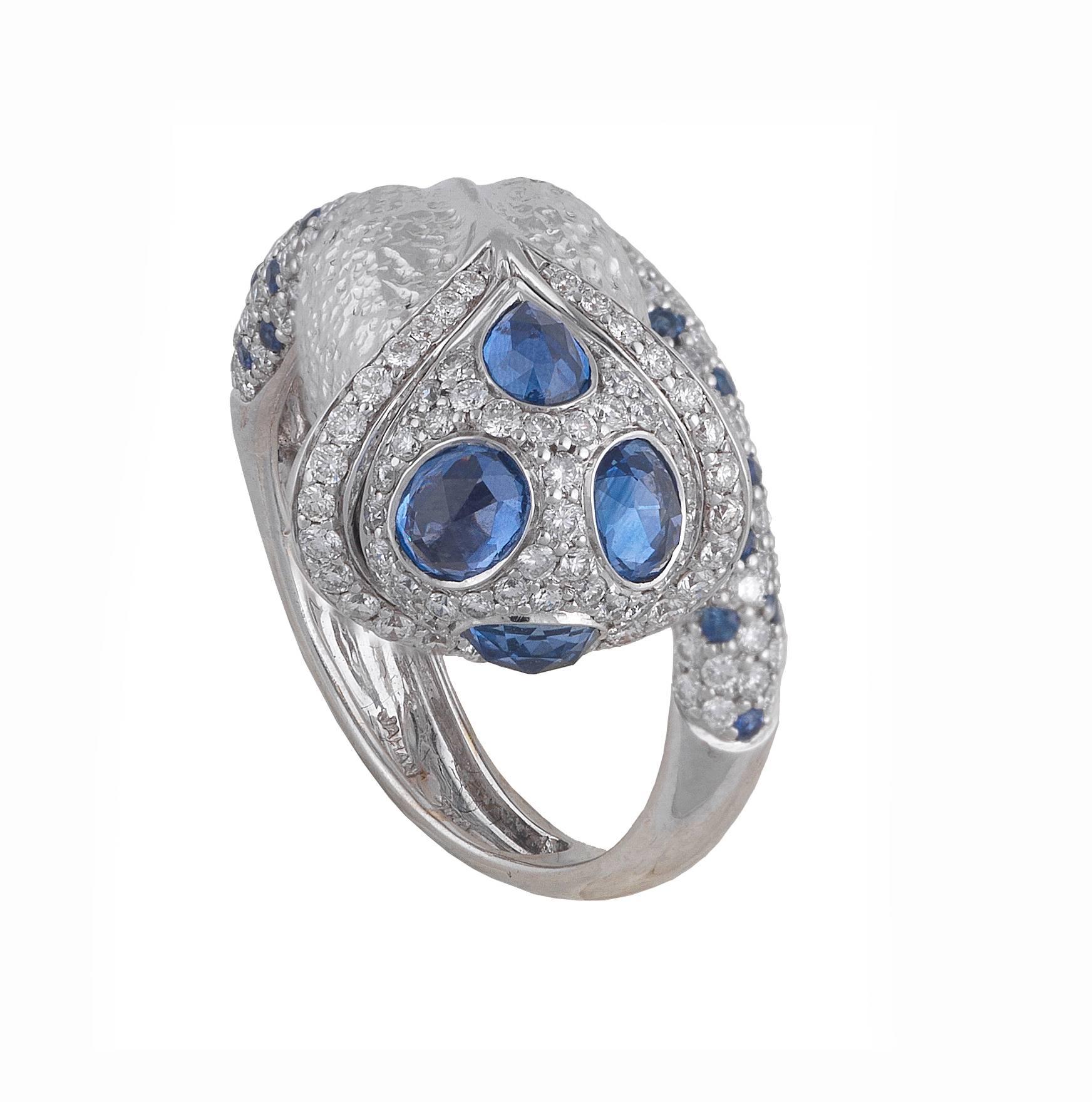 

Designed as a textured flower bud, inset with fancy-cut sapphires and brilliant-cut diamonds, to the similarly-set scrolling stem band. Stamped Jahan. Estimated total diamond weight 2cts. Ring size 9 1/4. Weight 13gms. 