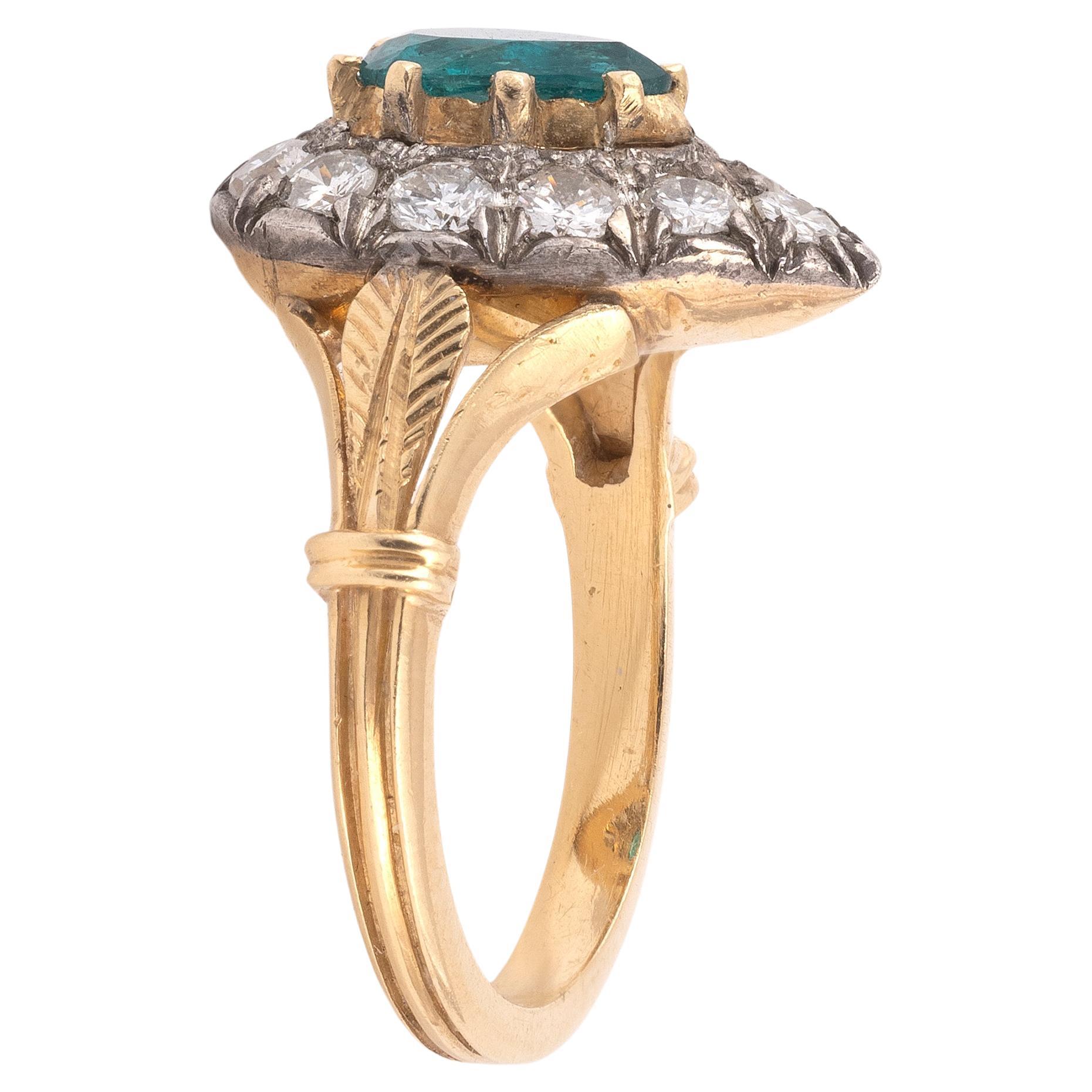 An antique 1.65ct Colombian, untreated emerald and diamond cluster ring, the central pear shaped emerald with an old mine cut diamond surround, mounted in silver and gold

Size 7

Weight: 7,54gr.